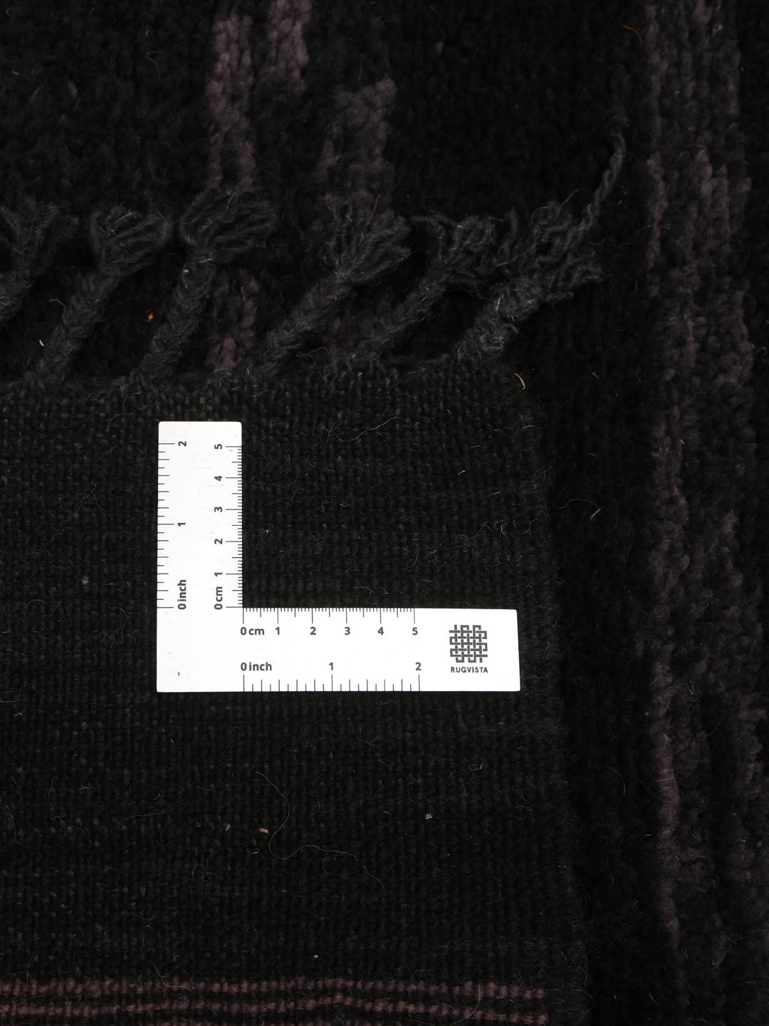 Hand-knotted black Berber Moroccan rug from Morocco featuring subtle horizontal accents.
