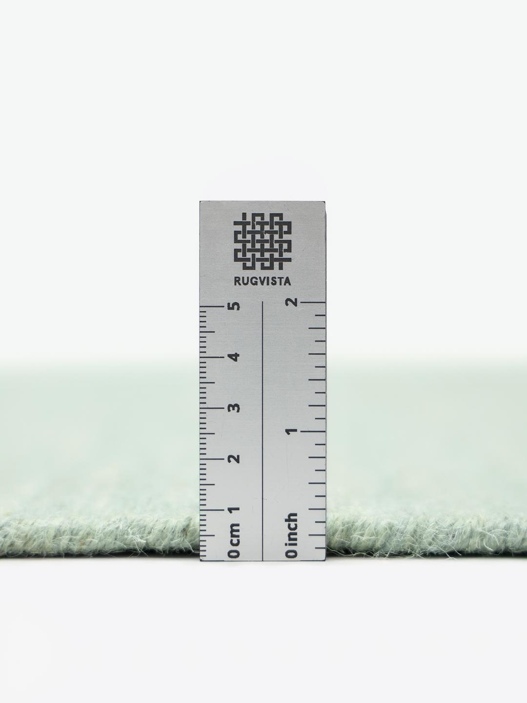 Rond groen vloerkleed in een platgeweven wollen afwerking
