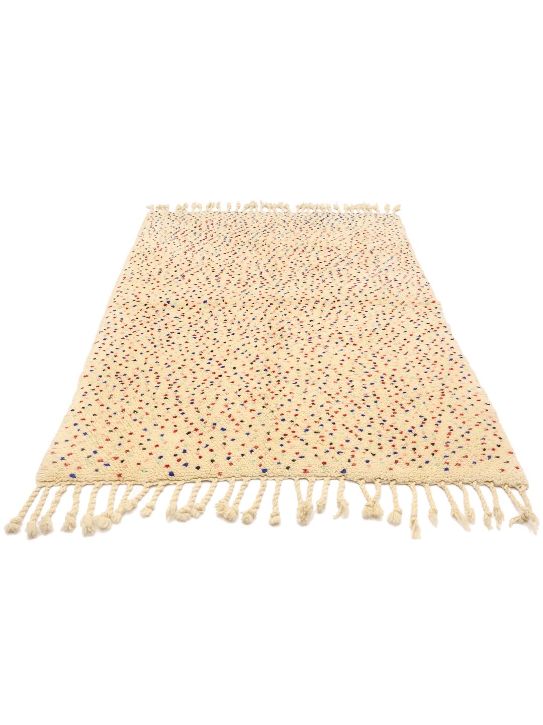 Handgemaakt Berber Marokkaans tapijt met meerkleurige spikkels op een beige achtergrond.