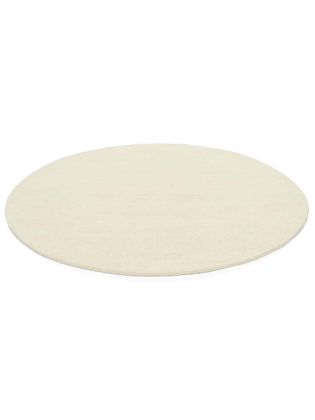 Un tapis rond blanc Handloom fabriqué en laine