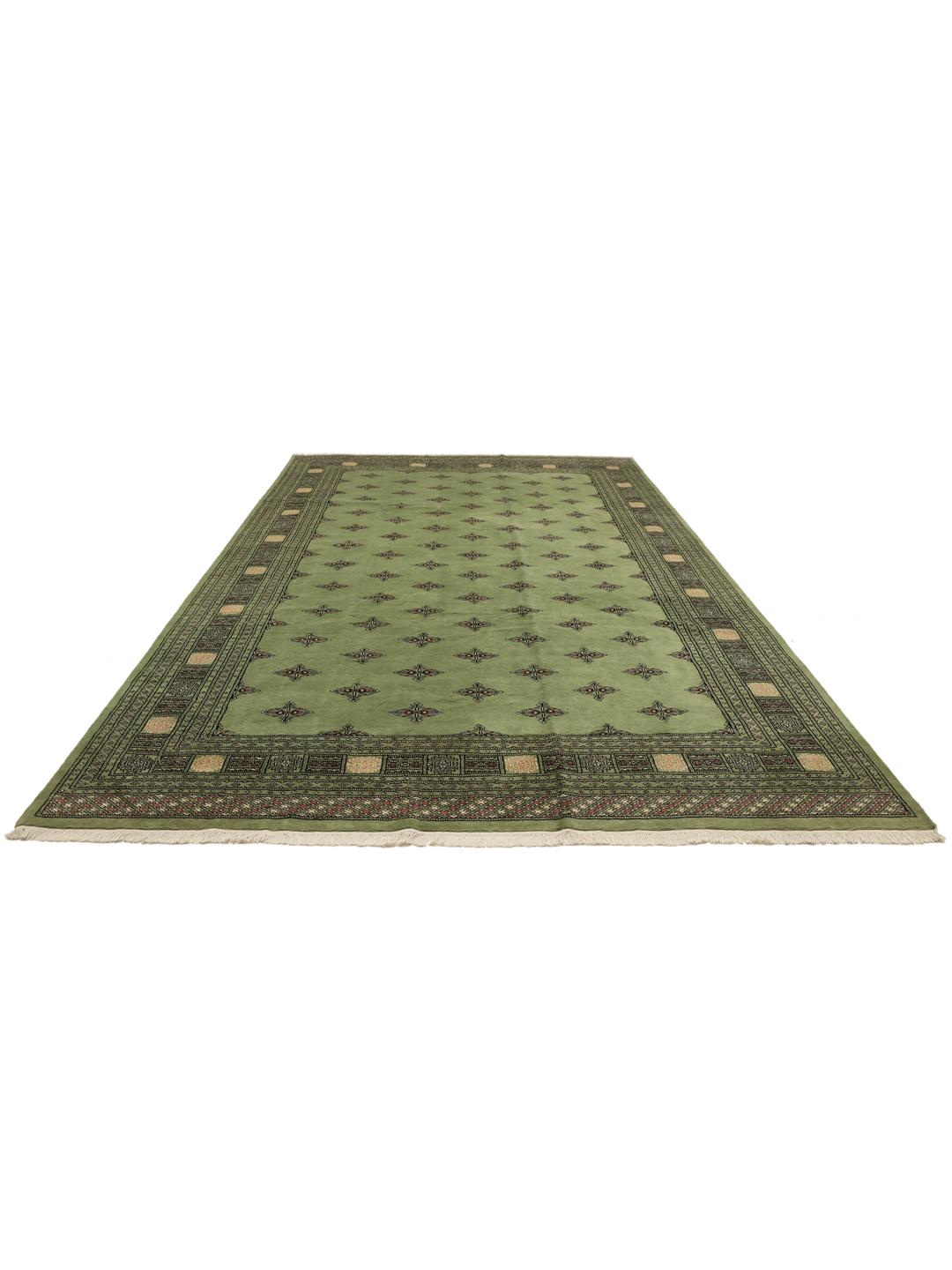 Hand-knotted Bokhara rug from Pakistan with a soft green field