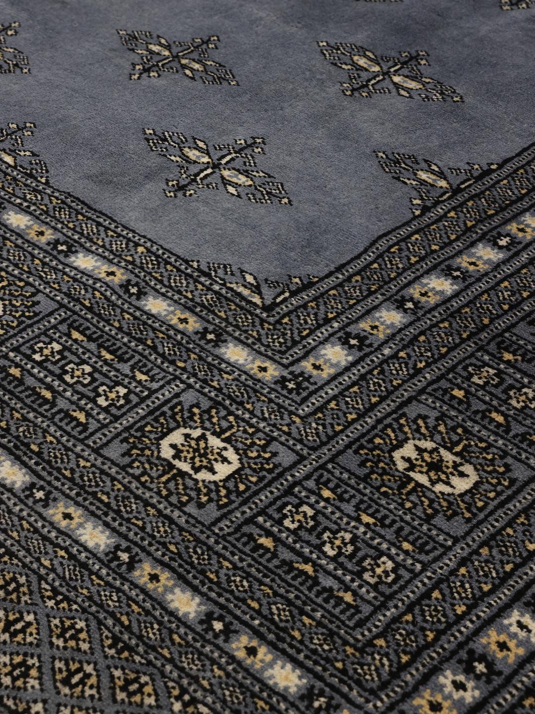 Hand-knotted Pakistani Bokhara rug in deep blue with repeating motifs