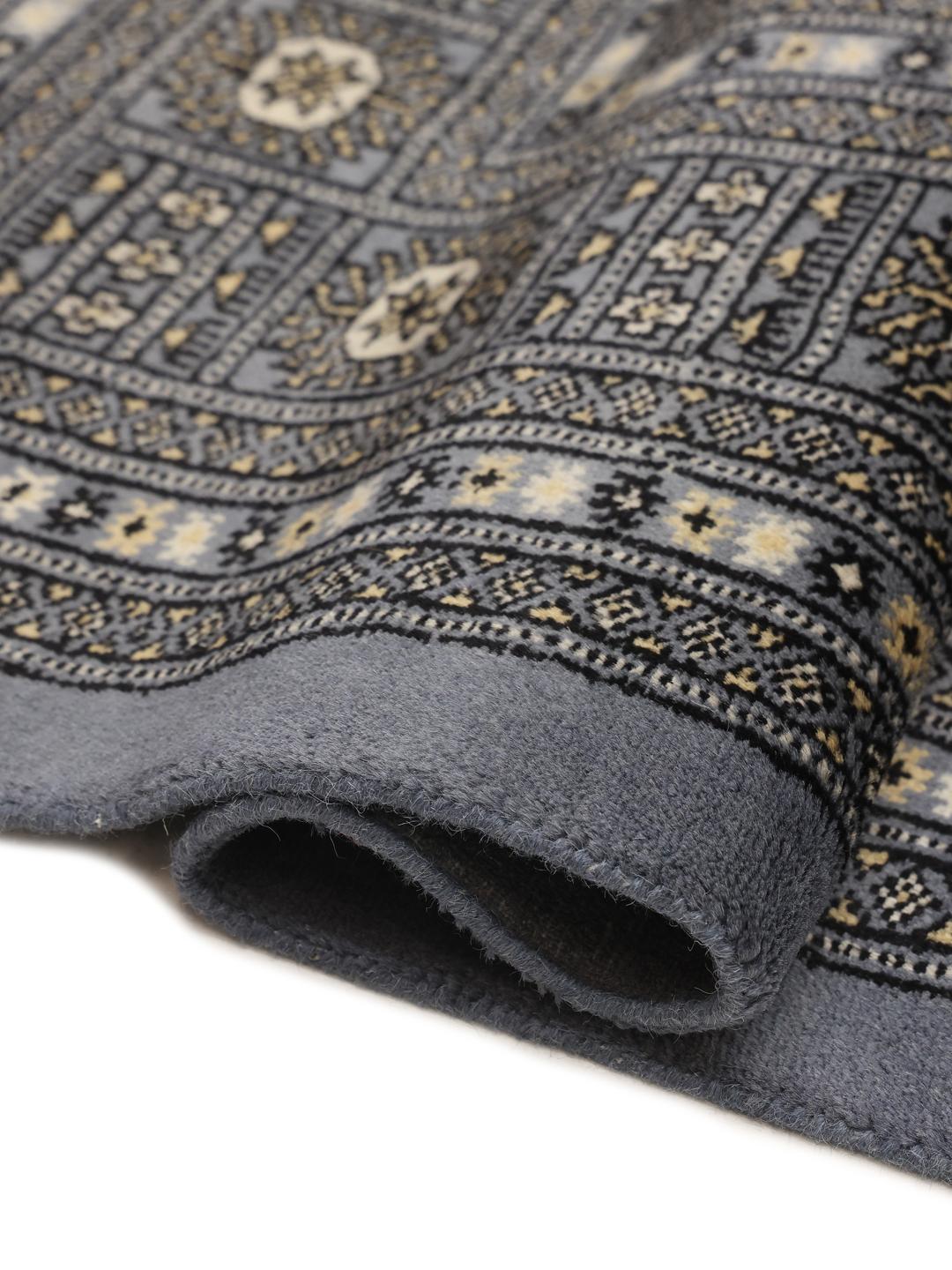 Hand-knotted Pakistani Bokhara rug in deep blue with repeating motifs