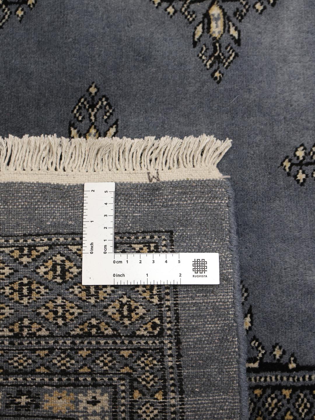 Hand-knotted Pakistani Bokhara rug in deep blue with repeating motifs