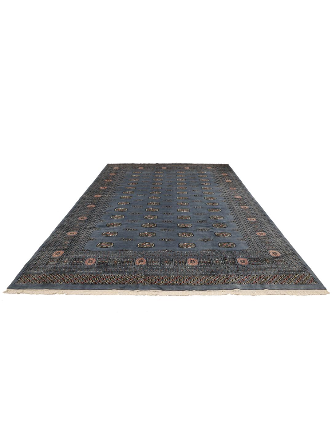 Hand-knotted blue Pakistani Bokhara rug with traditional gul motifs