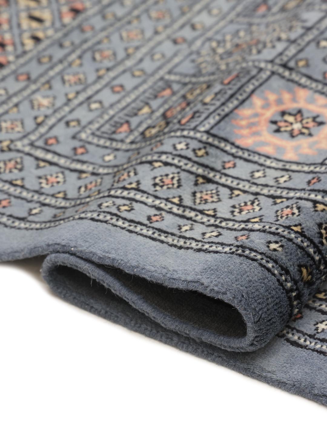 Hand-knotted blue Pakistani Bokhara rug with traditional gul motifs