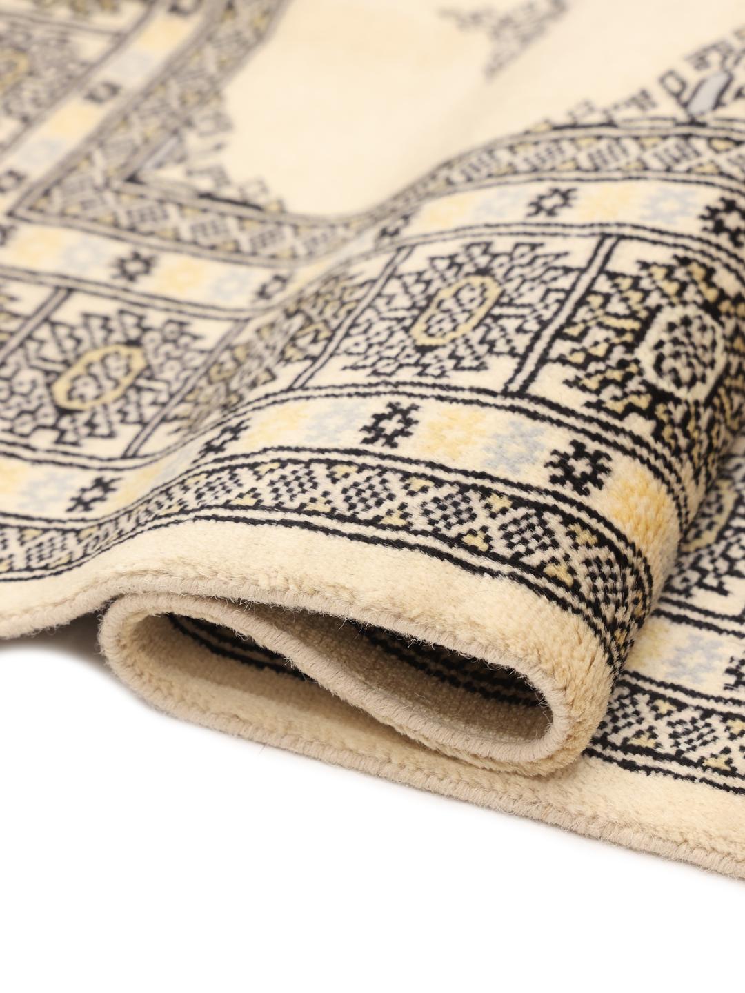 Hand-knotted Pakistani rug with beige field and geometric patterns