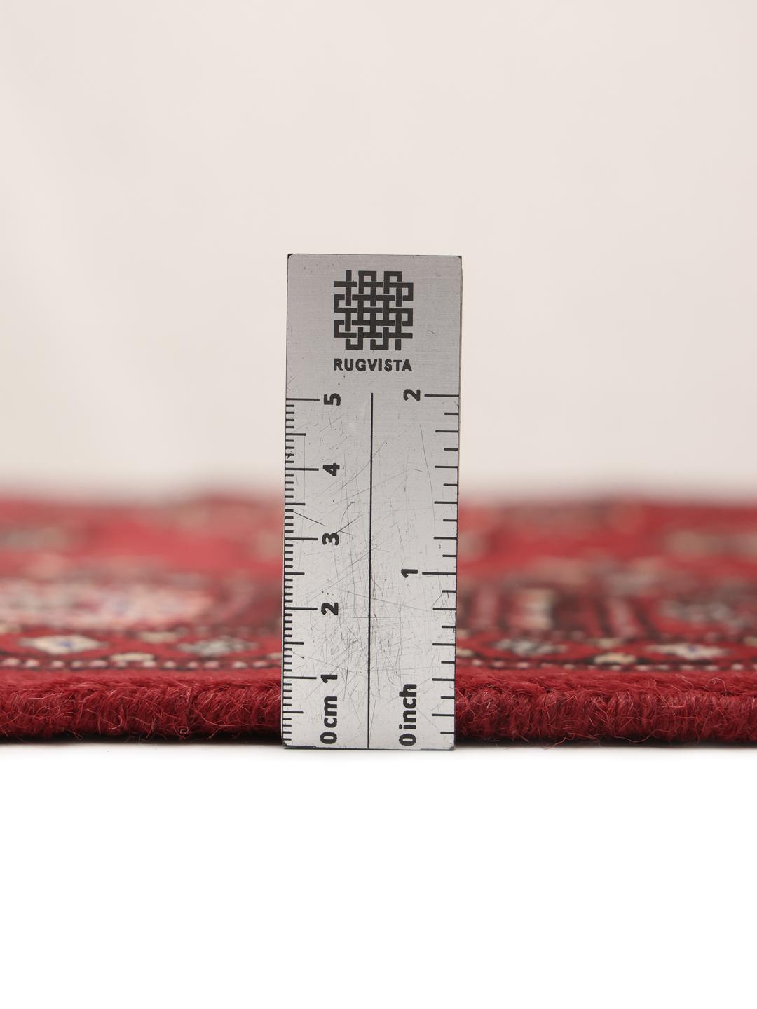 Hand-knotted Pakistani Bokhara rug in dark-red with traditional repeating motifs