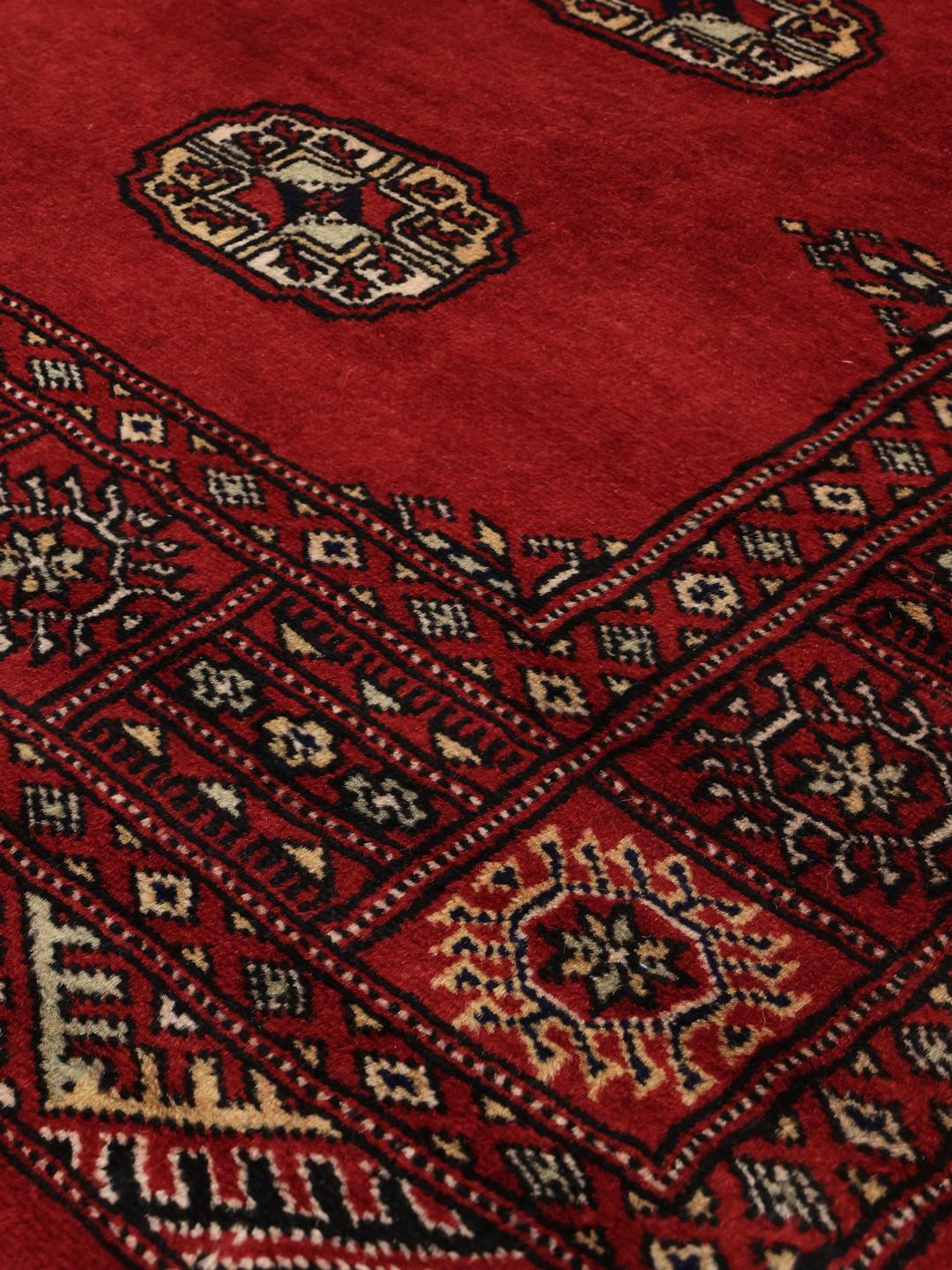 Hand-knotted red Bokhara rug from Pakistan