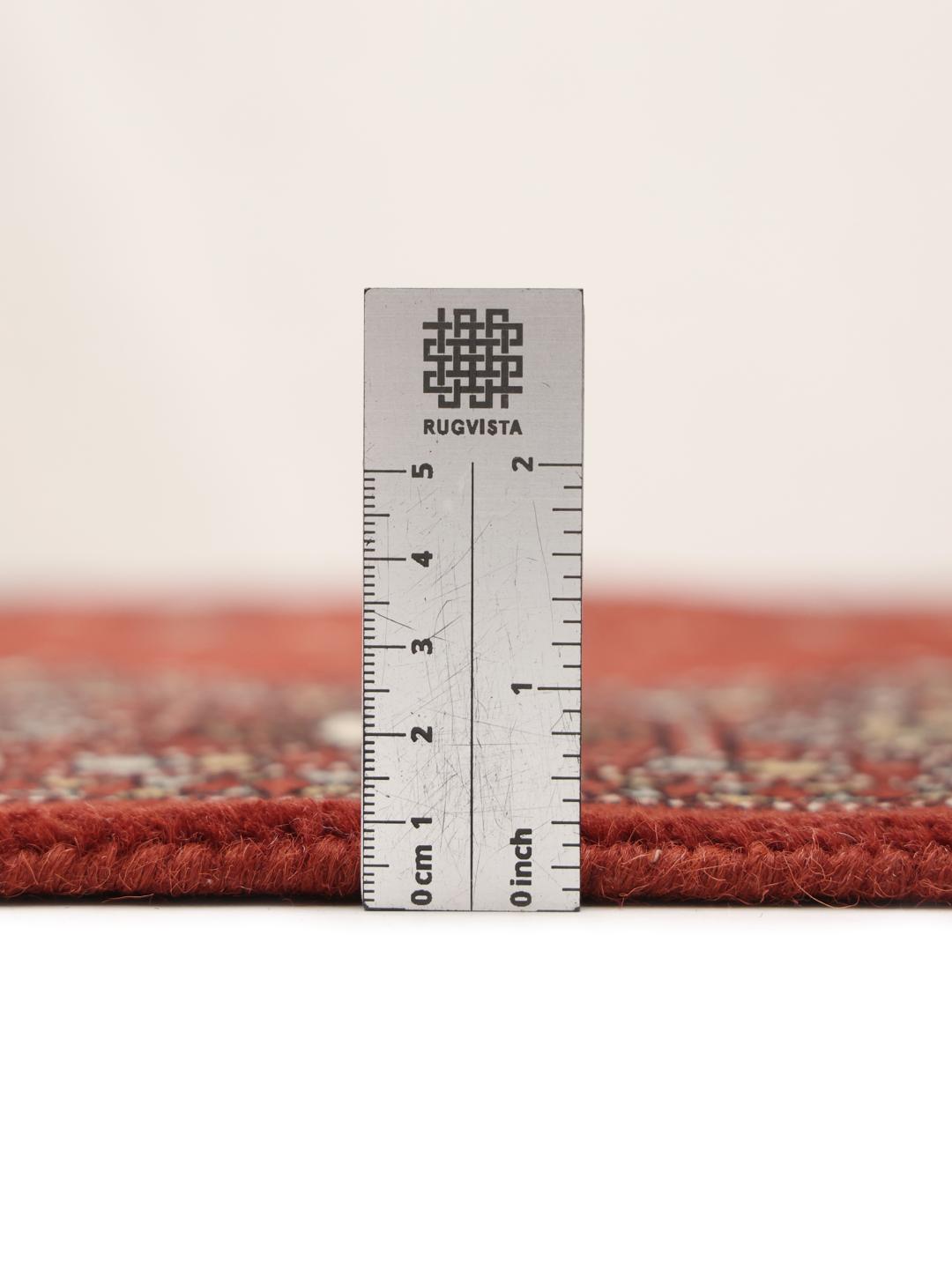 Hand-knotted Pakistani rug with a deep red field and repeating motifs