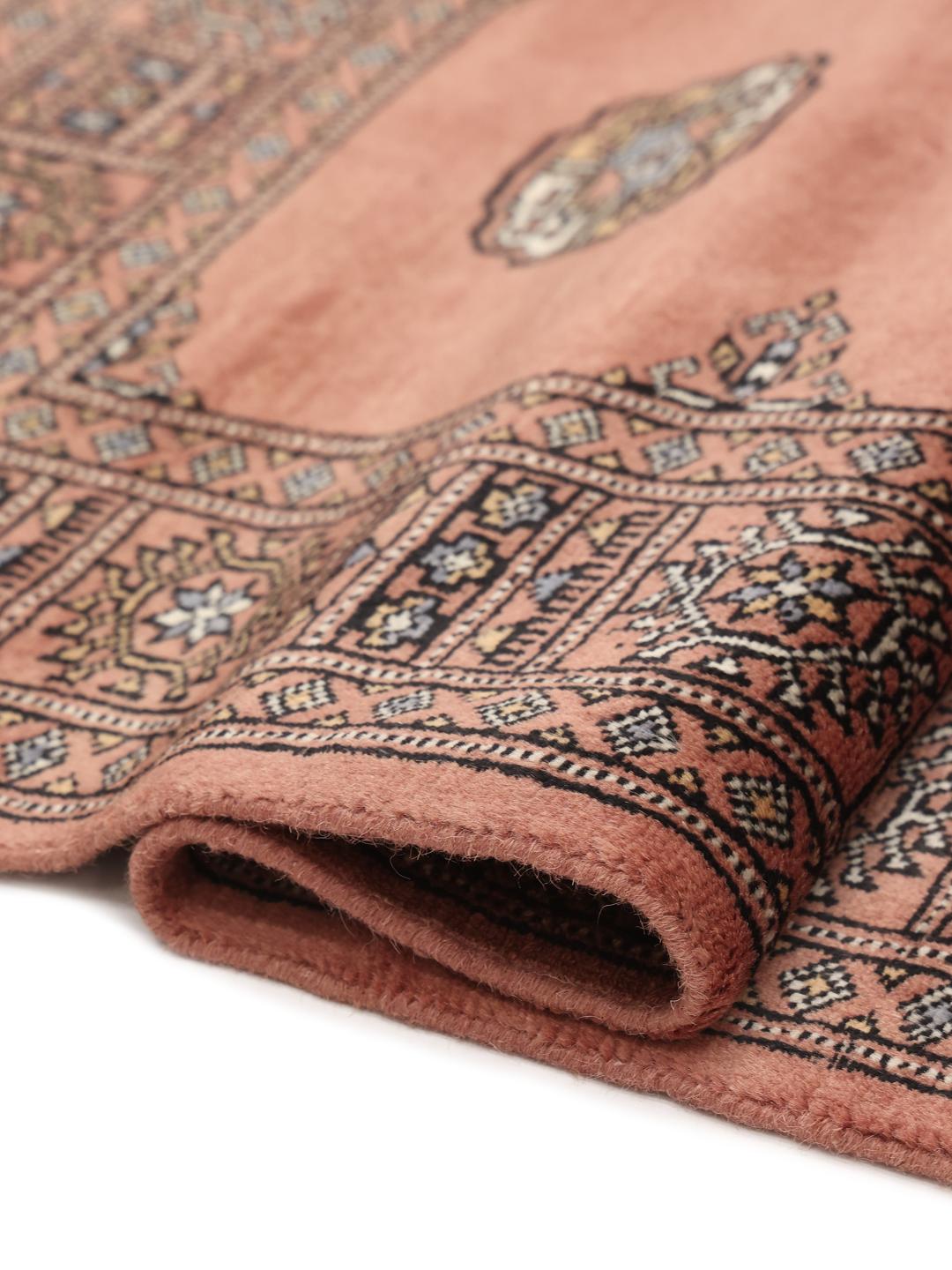 Hand-knotted dark-red Bokhara rug from Pakistan with traditional motifs