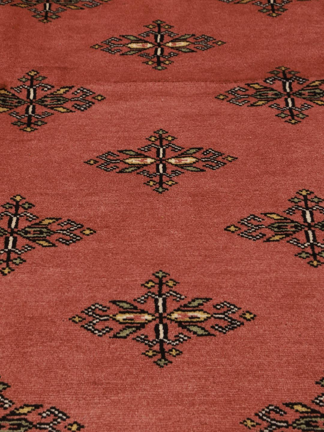 Hand-knotted Pakistani Bokhara rug in dark-red with geometric medallions