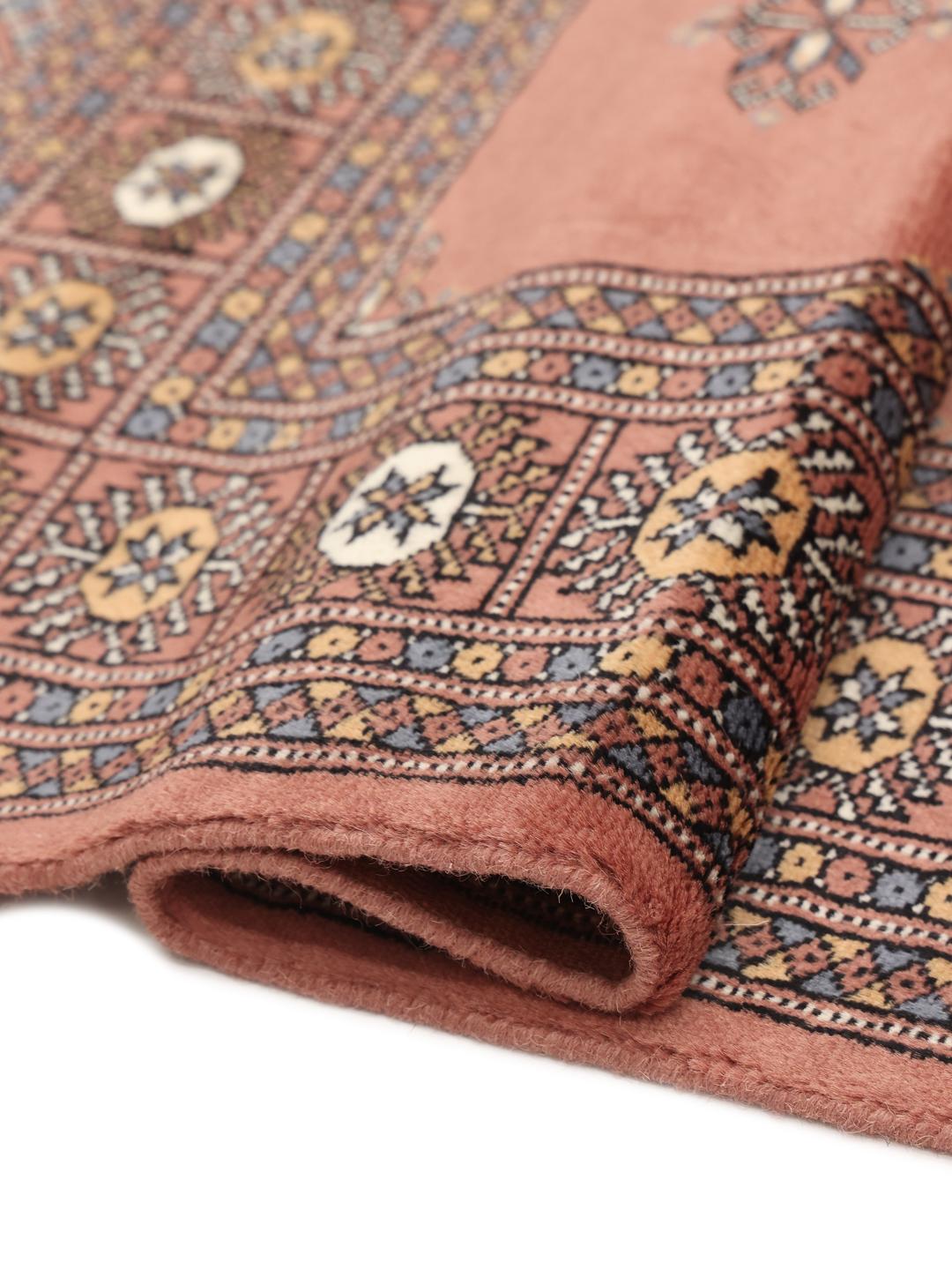 Hand-knotted red Bokhara rug from Pakistan with traditional motifs