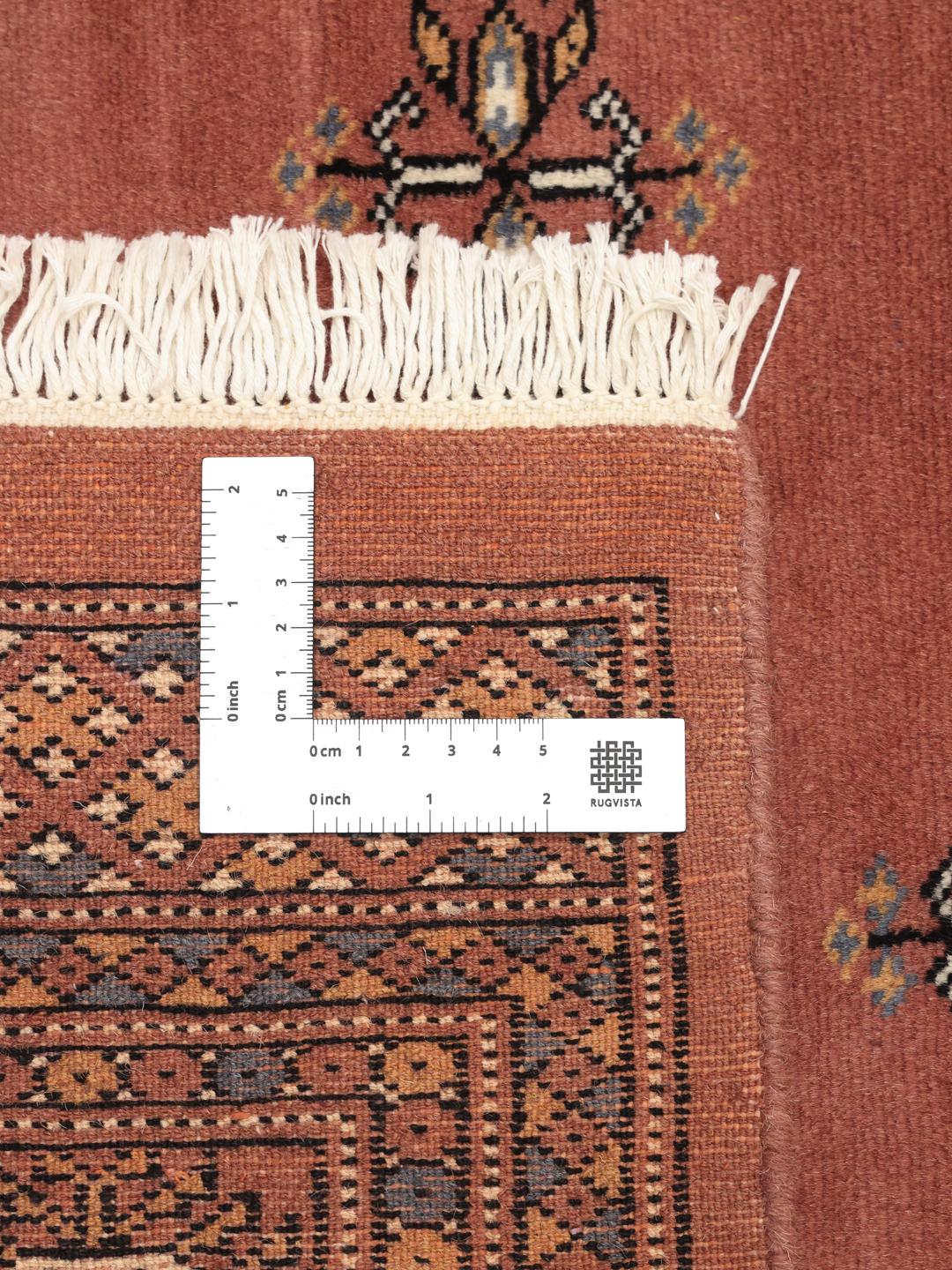 Hand-knotted red Bokhara rug from Pakistan with traditional motifs