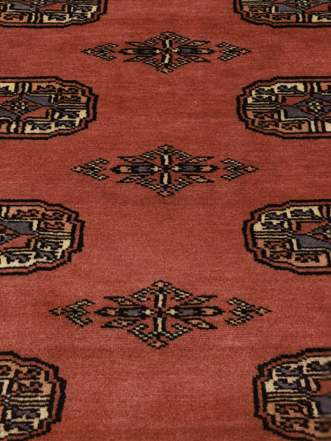 Hand-knotted Bokhara rug from Pakistan in red tones