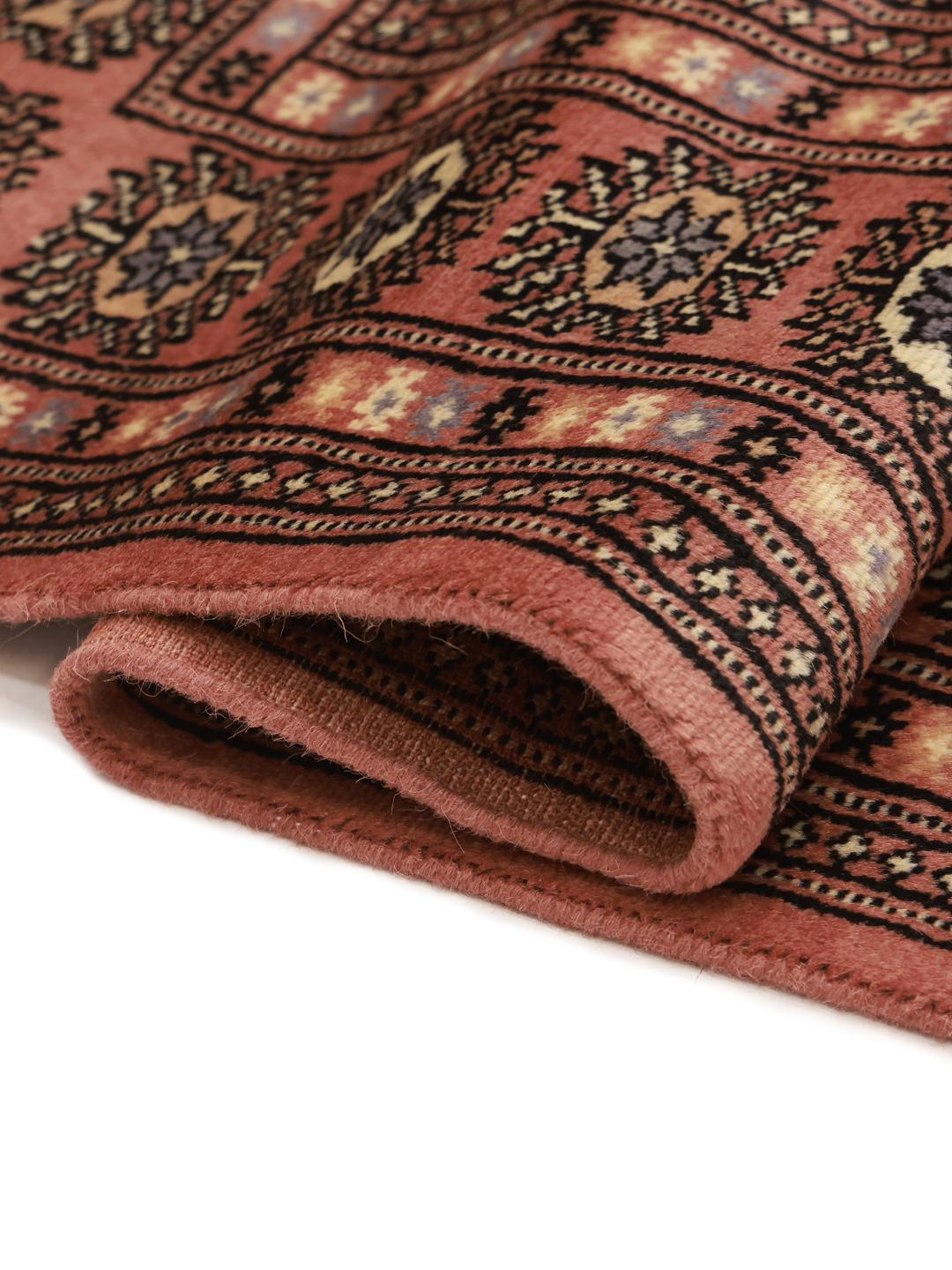 Hand-knotted Bokhara rug from Pakistan in red tones