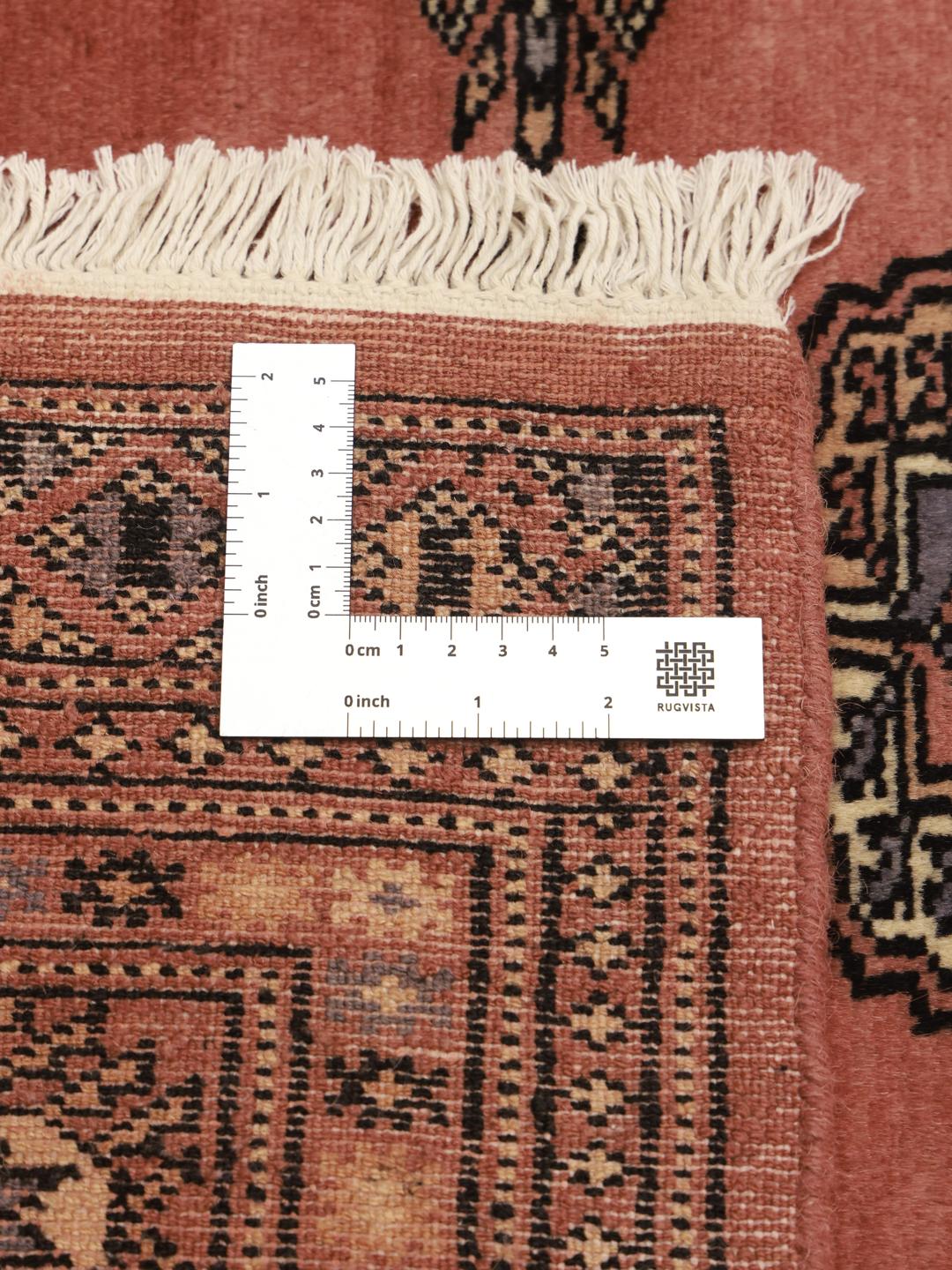 Hand-knotted Bokhara rug from Pakistan in red tones