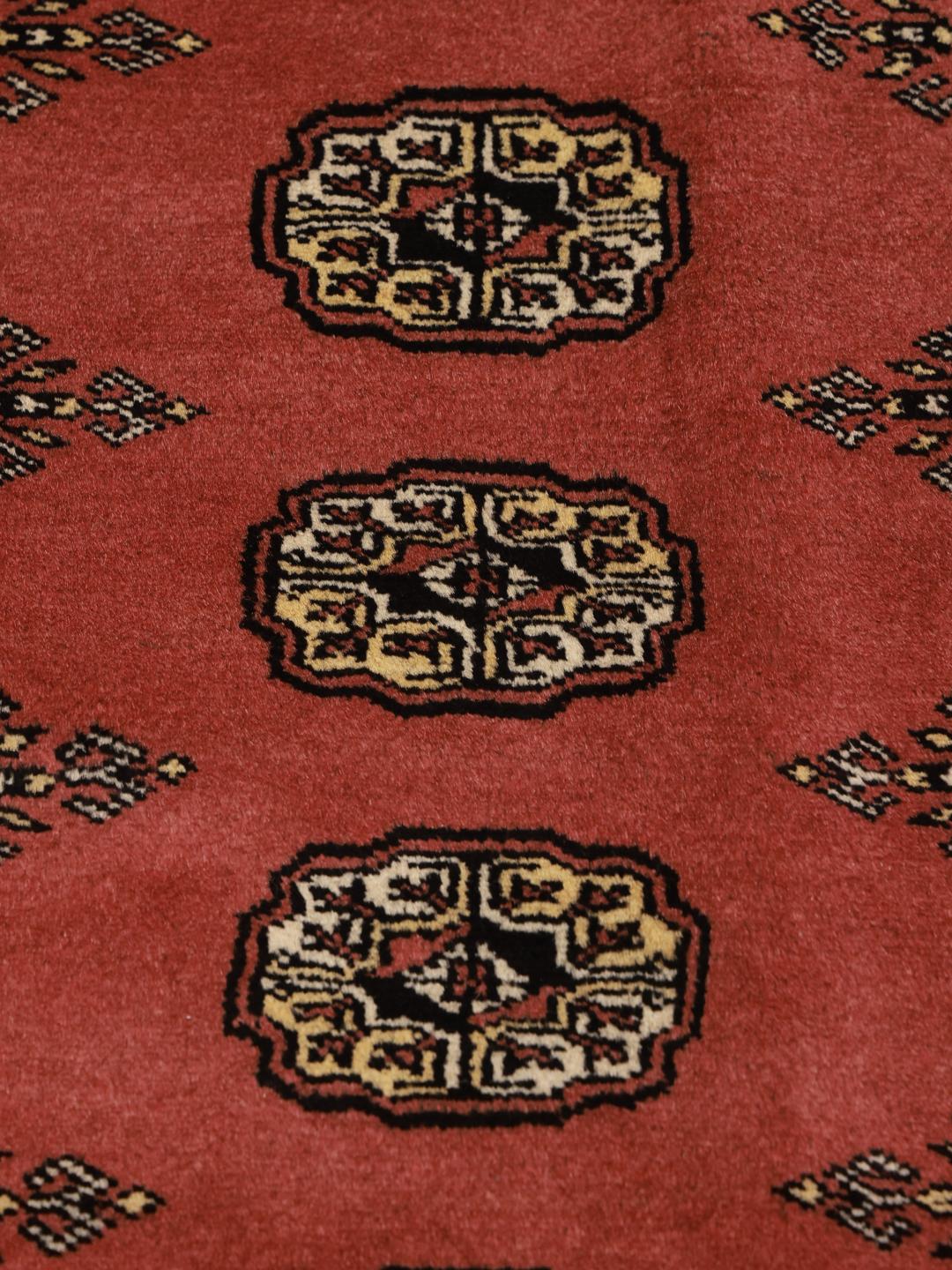 Hand-knotted Pakistan rug with red field and traditional gul motifs