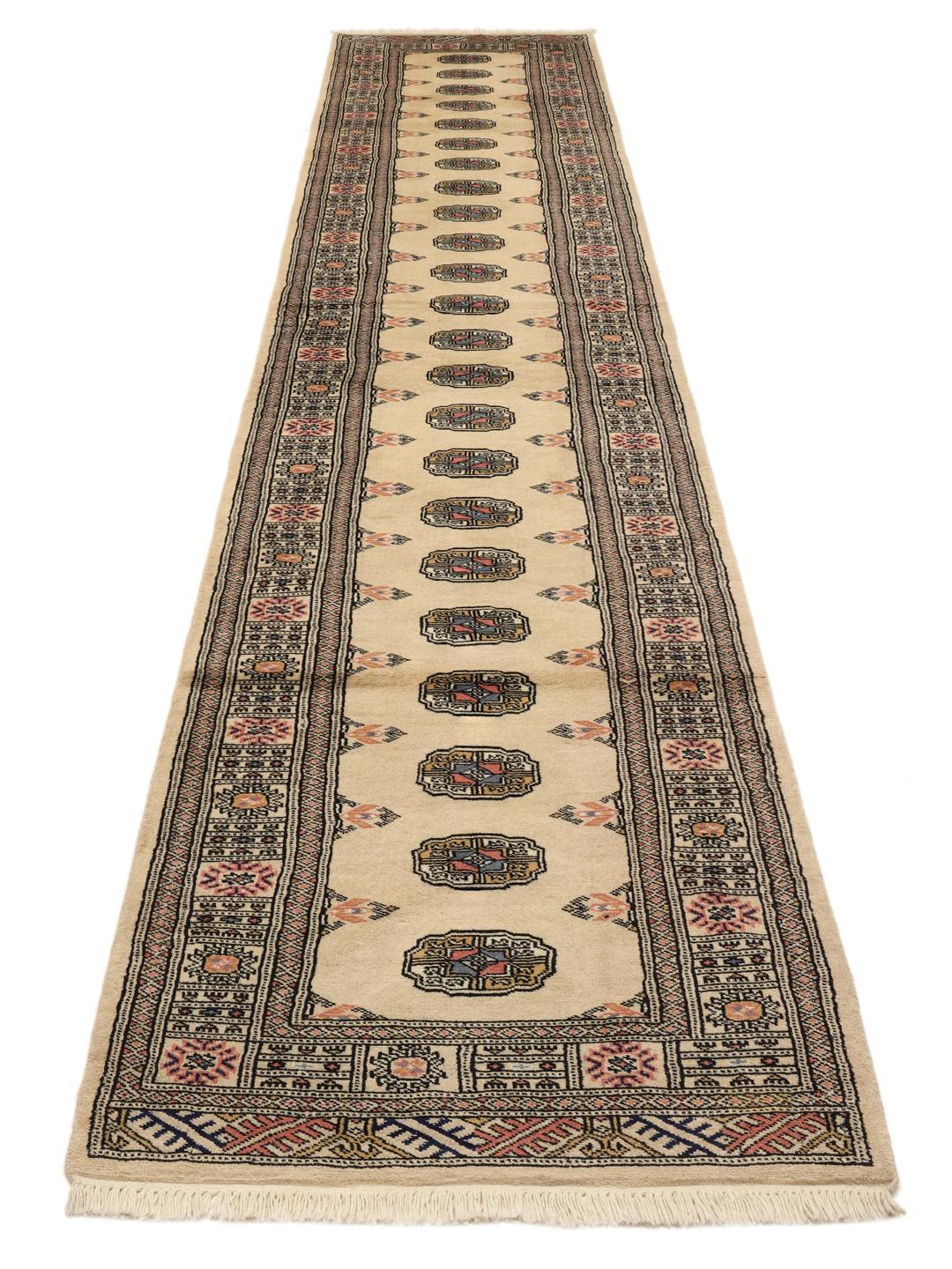 Hand-knotted beige Pakistan runner with a traditional decorative border