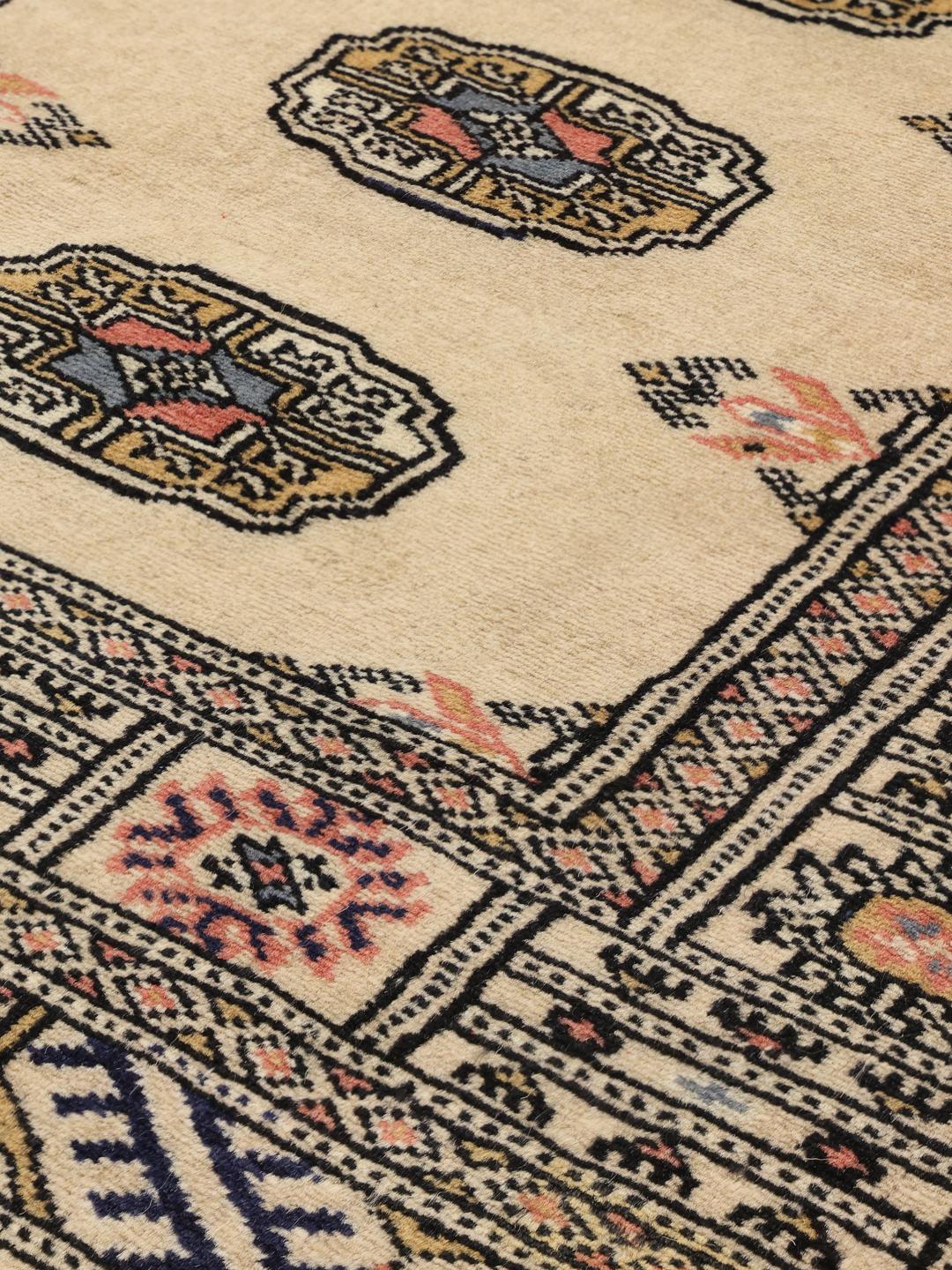 Hand-knotted beige Pakistan runner with a traditional decorative border
