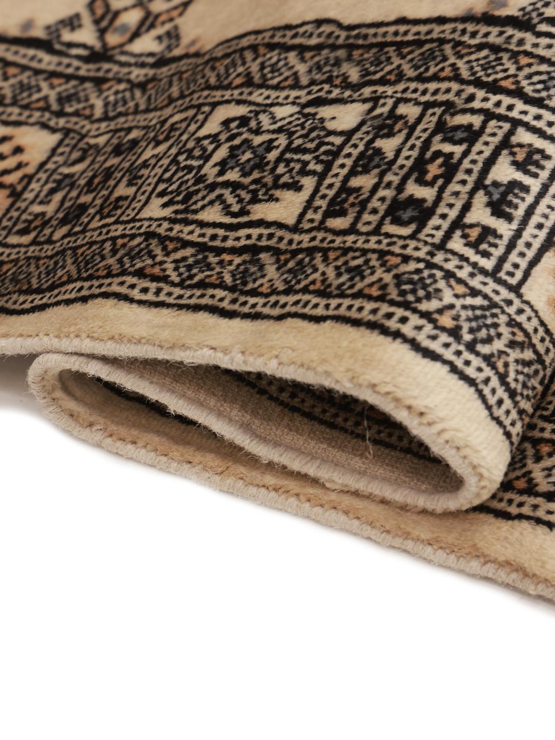 Hand-knotted Pakistani Bokhara runner in beige with intricate dark motifs.