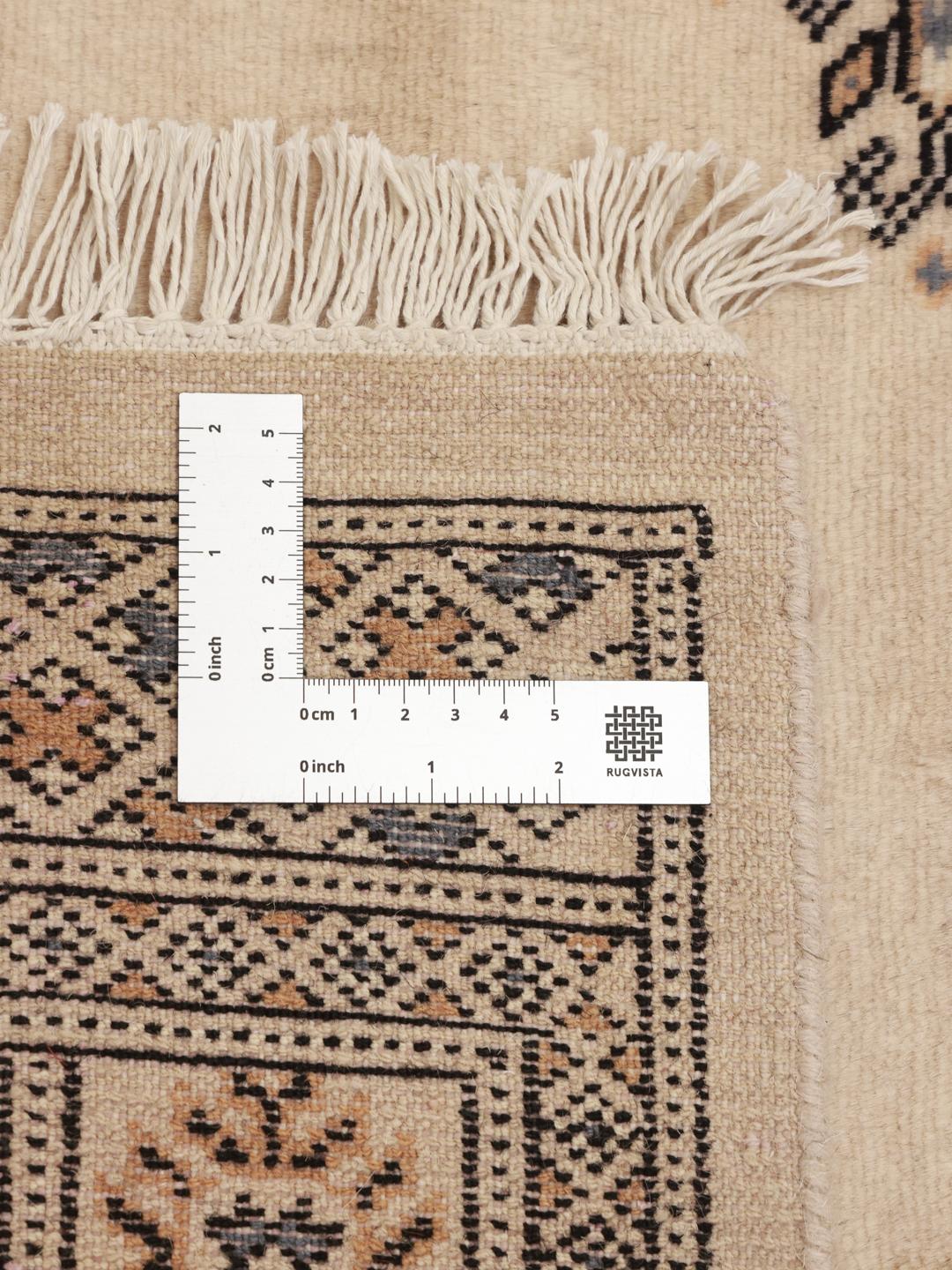 Hand-knotted Pakistani Bokhara runner in beige with intricate dark motifs.
