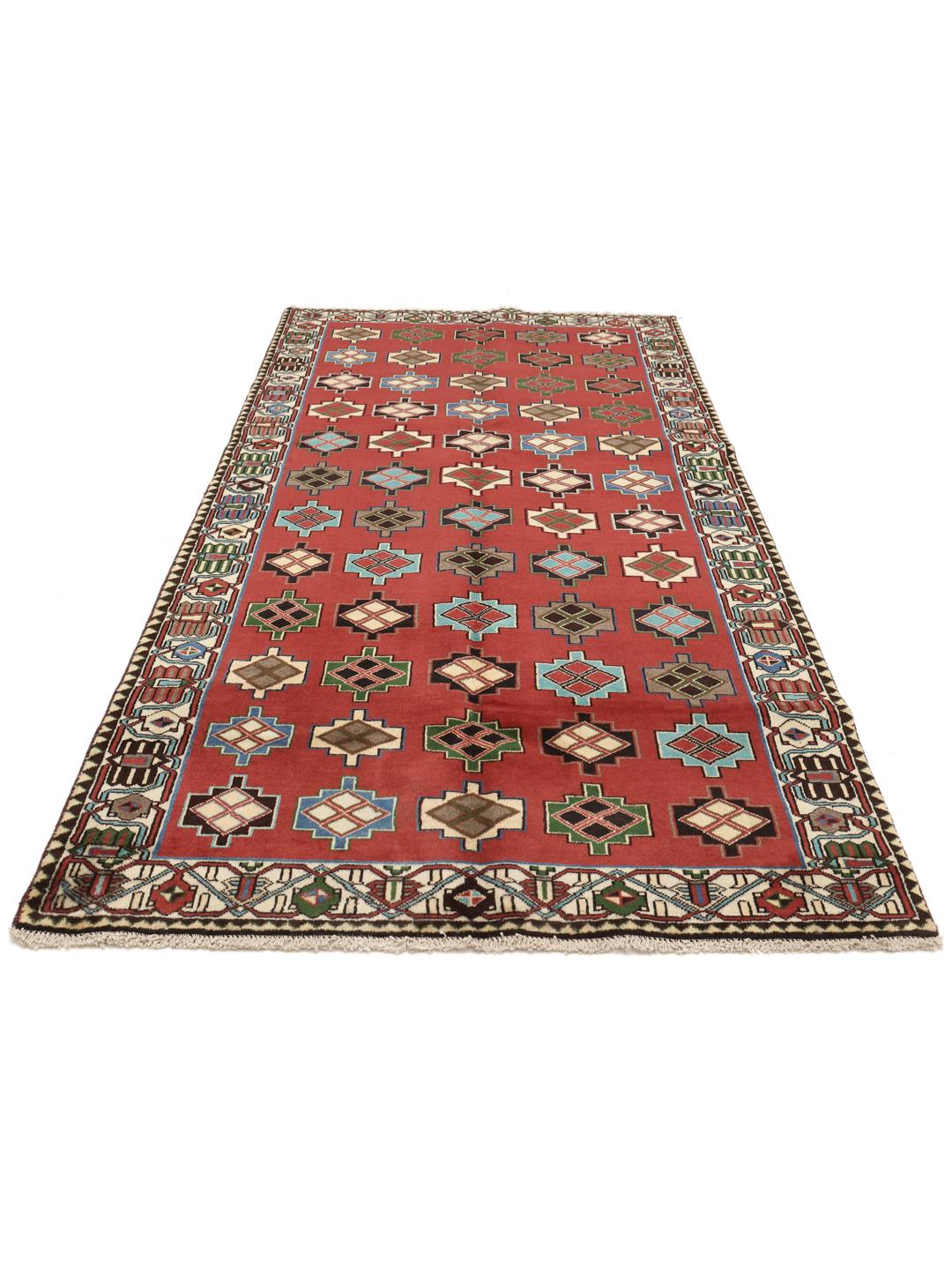 A hand-knotted Shiraz rug from the Middle East in a deep red colour with geometric patterns.