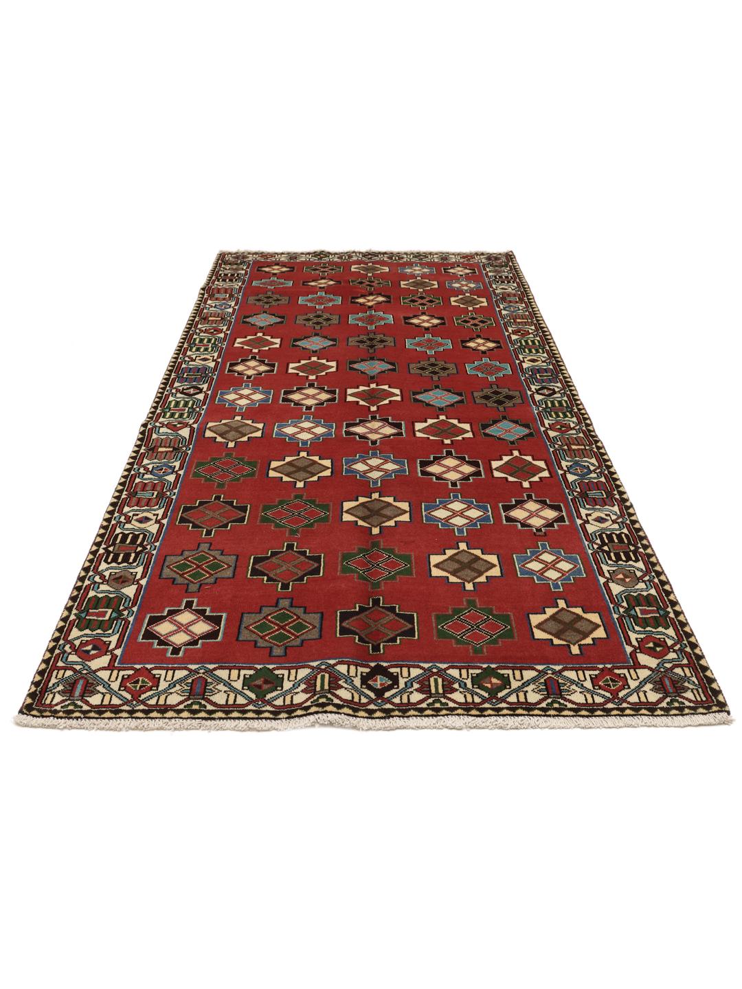 A hand-knotted Shiraz rug from the Middle East in a deep red colour with geometric patterns.