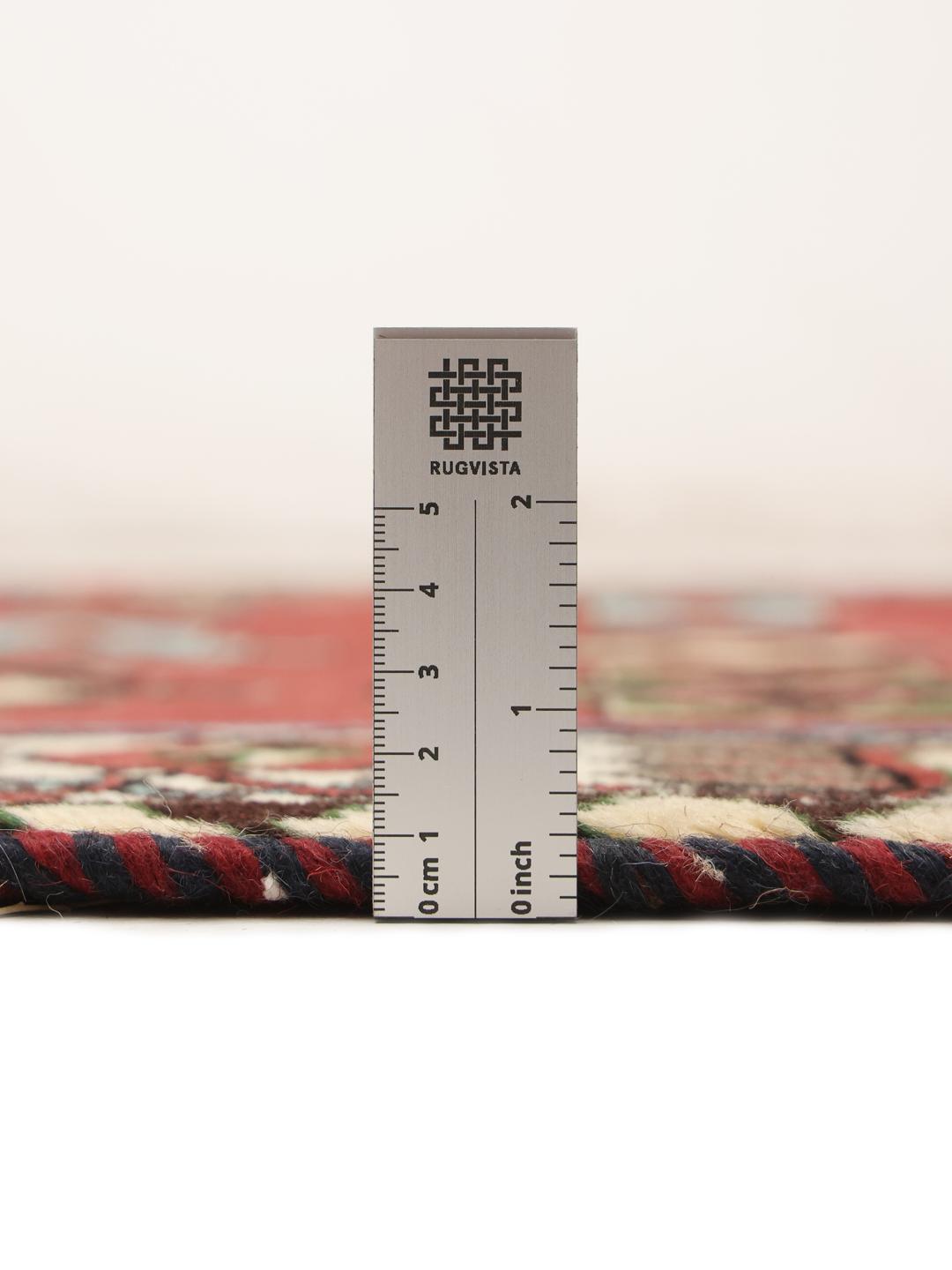 A hand-knotted Shiraz rug from the Middle East in a deep red colour with geometric patterns.