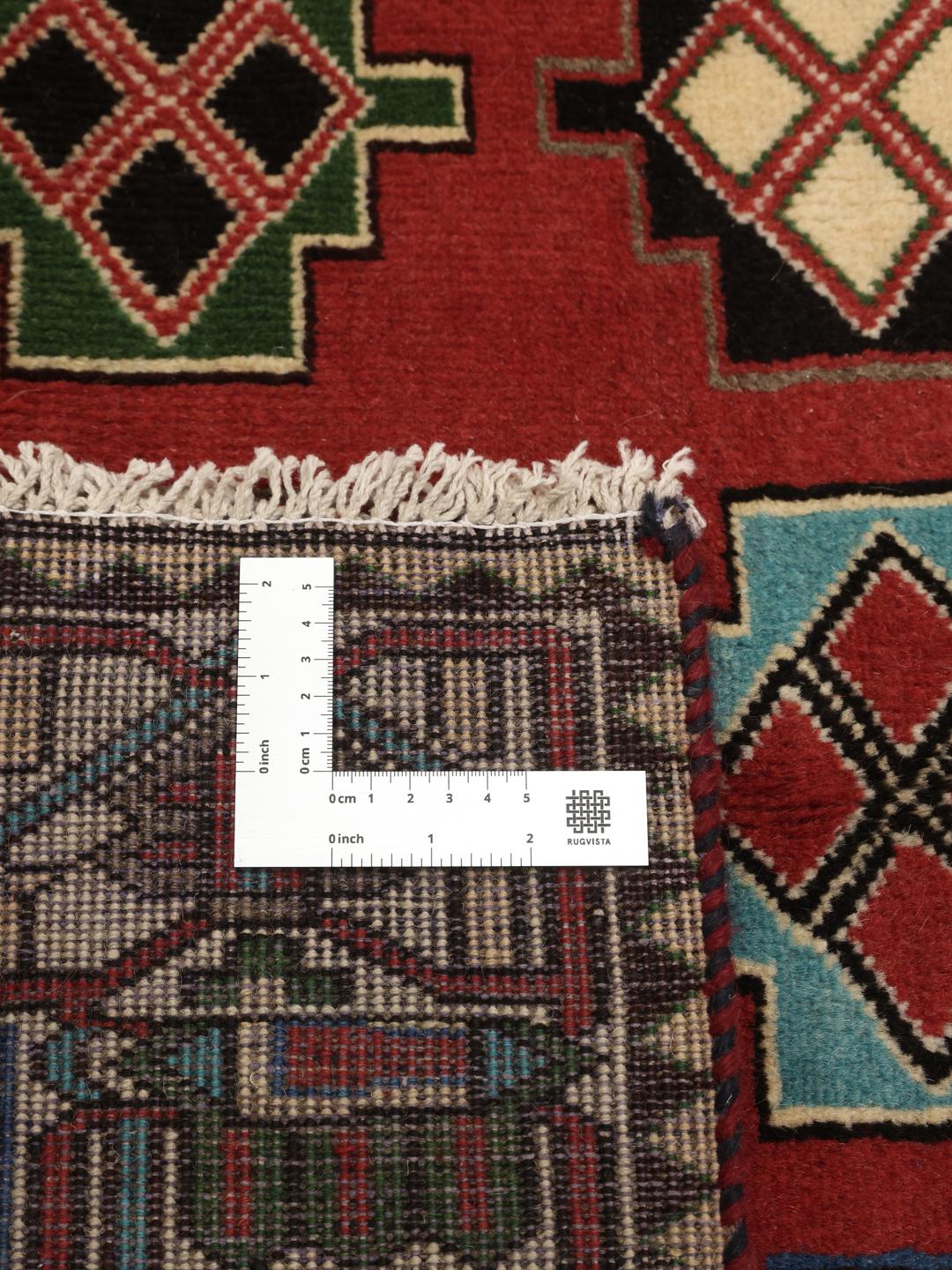 A hand-knotted Shiraz rug from the Middle East in a deep red colour with geometric patterns.