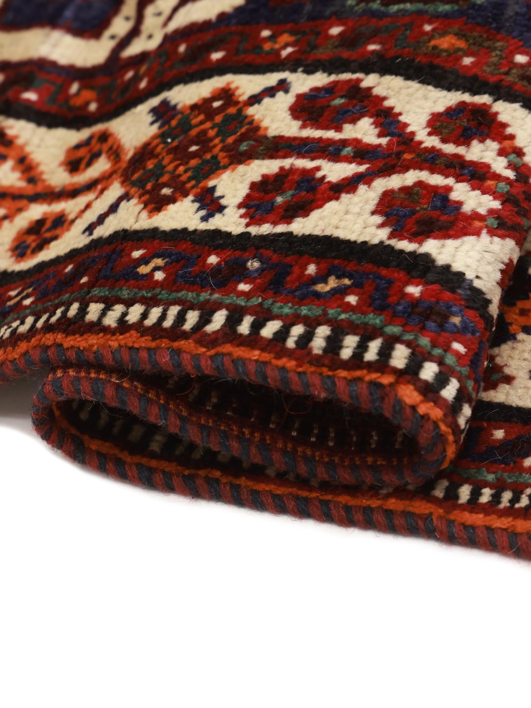 Hand-knotted Shiraz rug with geometric patterns in deep red and blue tones from the Middle East