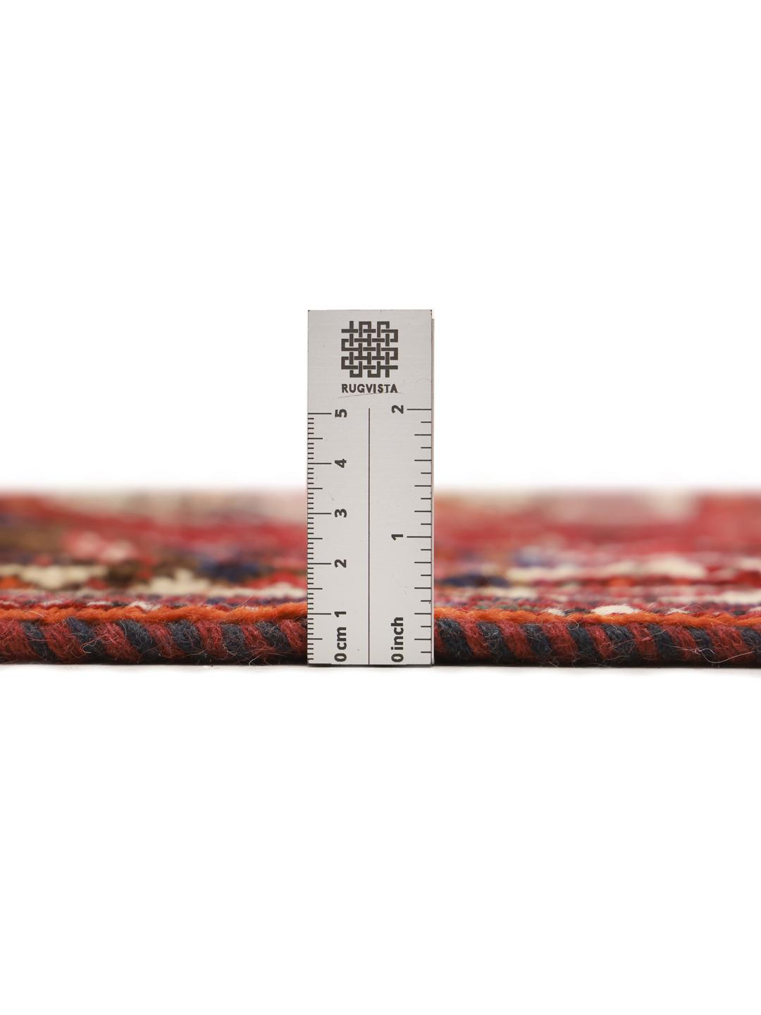 Hand-knotted Shiraz rug with geometric patterns in deep red and blue tones from the Middle East