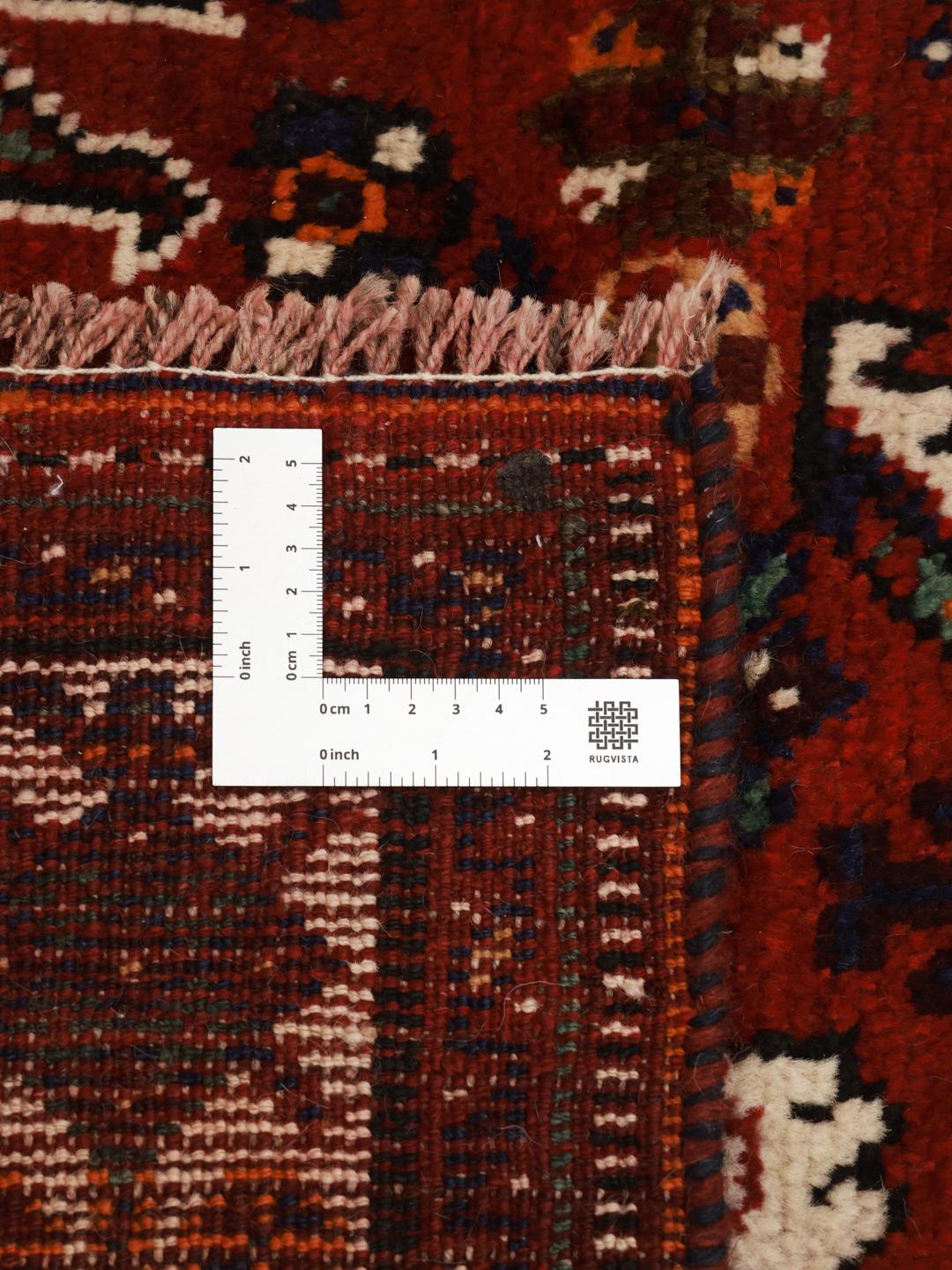 Hand-knotted Shiraz rug with geometric patterns in deep red and blue tones from the Middle East