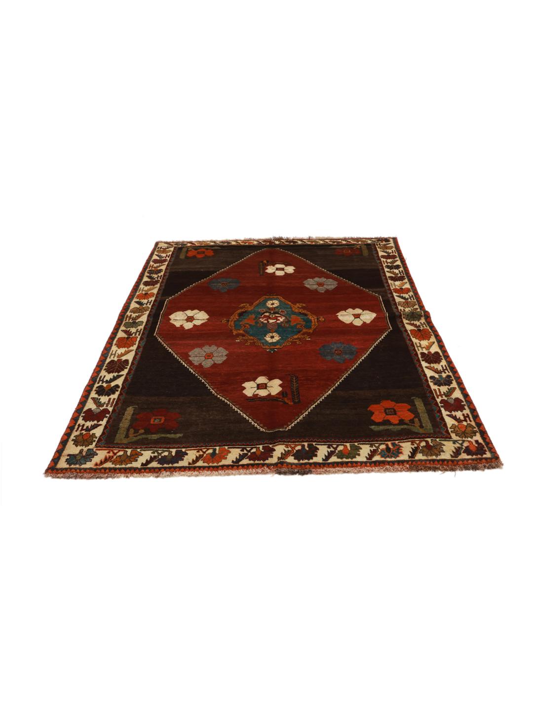 A hand-knotted Shiraz rug from the Middle East featuring a dark red field with floral motifs in a vibrant, decorative style.