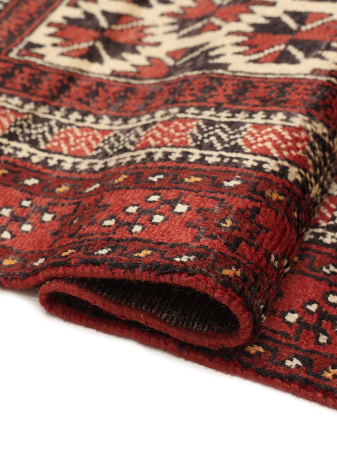 Authentic hand-knotted Baluch rug in red, featuring traditional geometric patterns