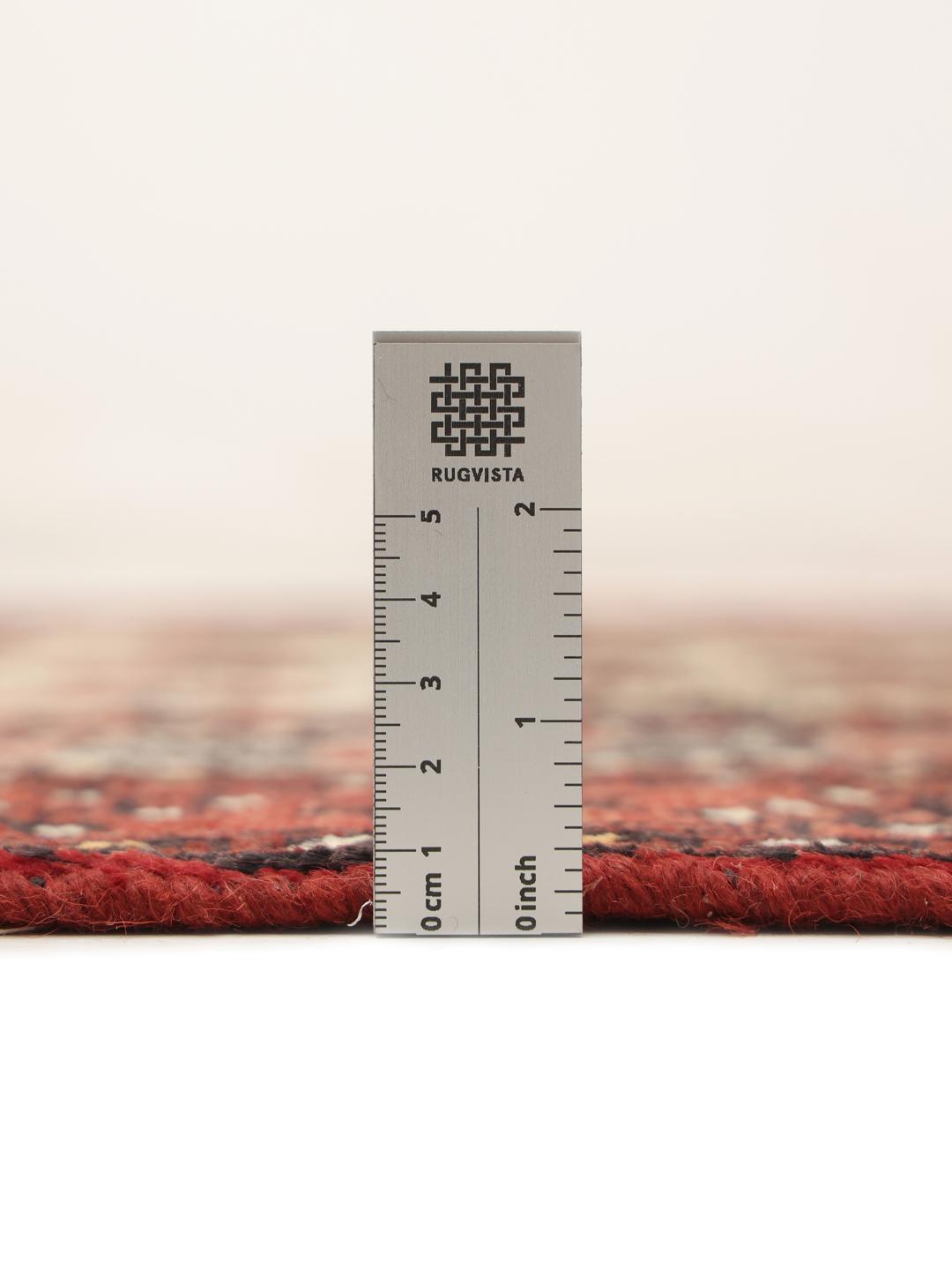 Authentic hand-knotted Baluch rug in red, featuring traditional geometric patterns