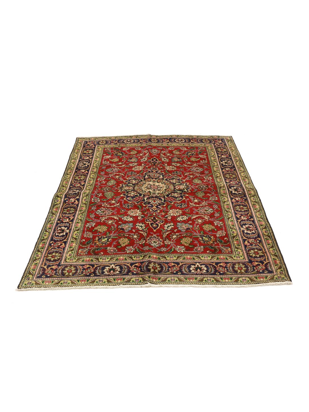A hand-knotted Tabriz rug from the Middle East featuring a vibrant red field with a blue central medallion.