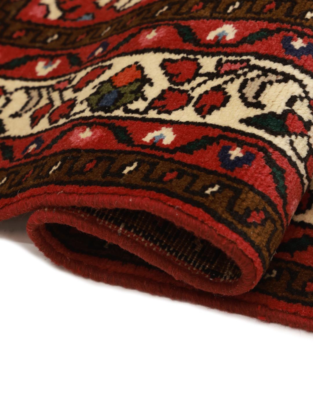 Hand-knotted Hosseinabad rug with a rich red field and traditional Middle Eastern motifs.
