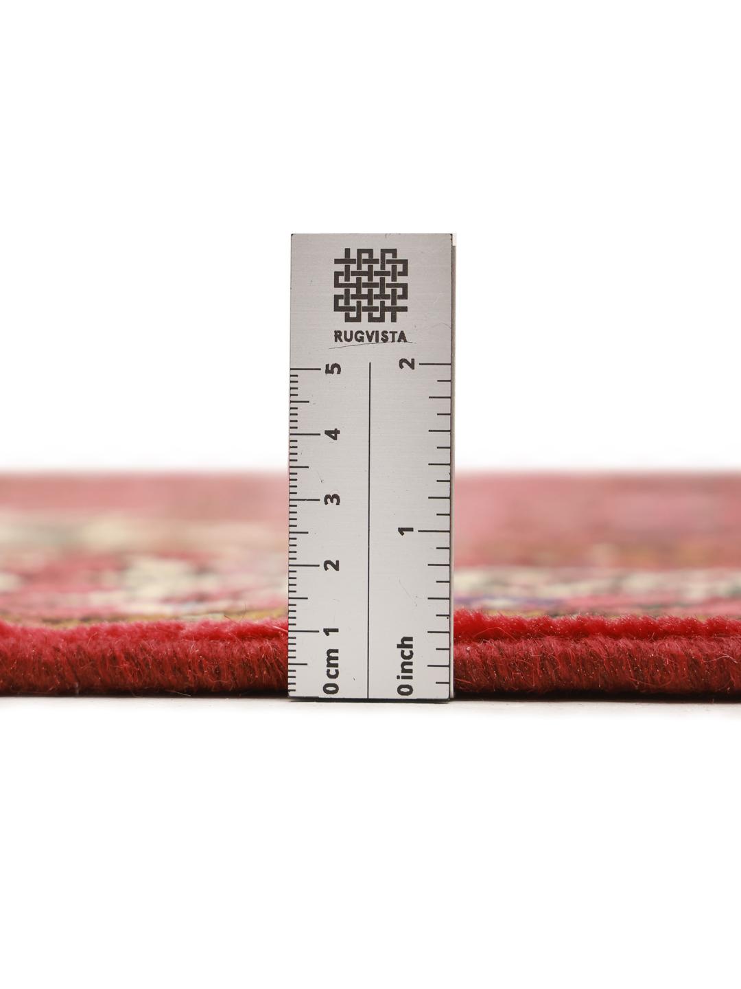 Hand-knotted Hosseinabad rug with a rich red field and traditional Middle Eastern motifs.