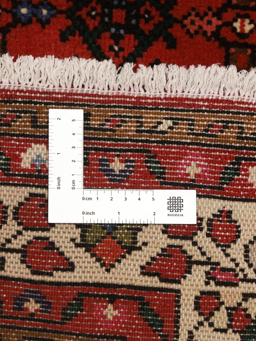 Hand-knotted Hosseinabad rug with a rich red field and traditional Middle Eastern motifs.