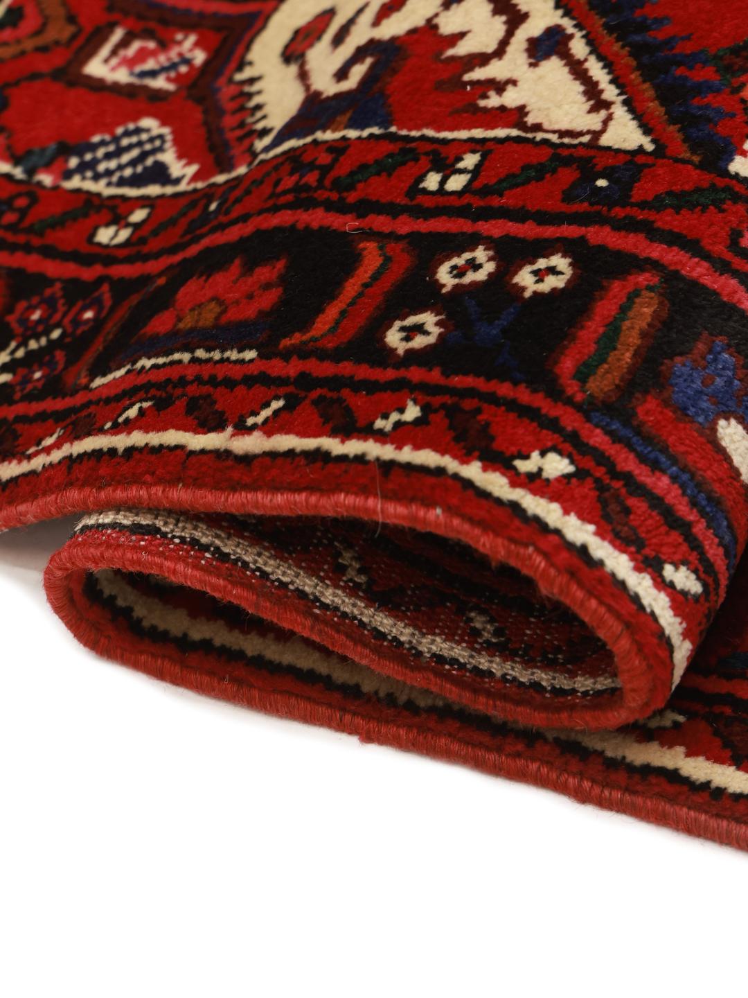 Hand-knotted Hosseinabad Wool rug from the Middle East in red and black colours