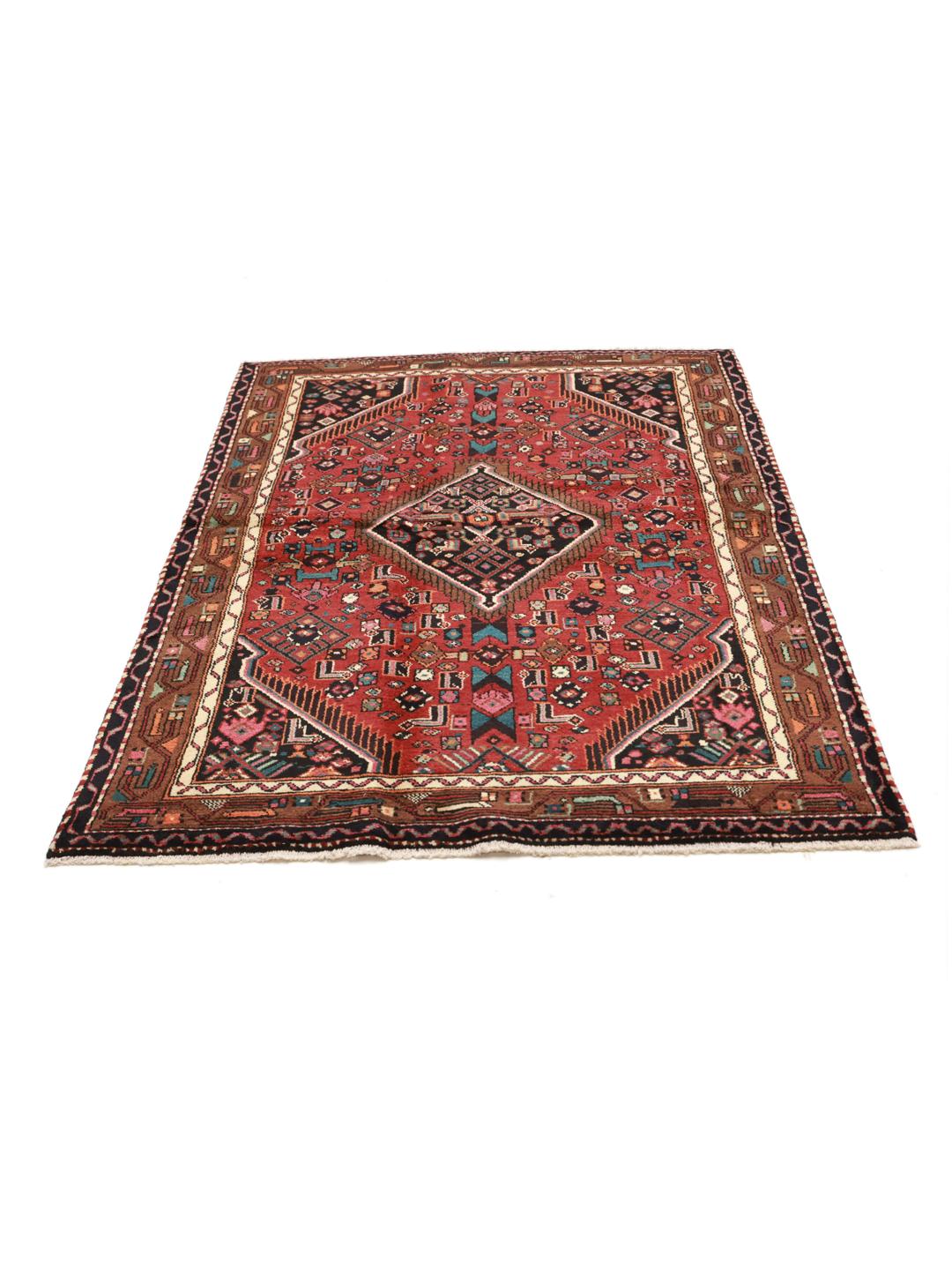 A hand-knotted Hamadan rug from the Middle East featuring a dark-red field with geometric motifs.