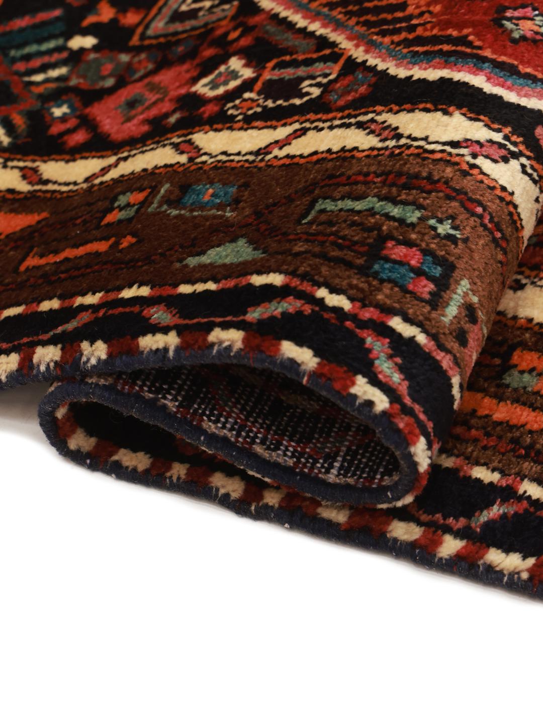 A hand-knotted Hamadan rug from the Middle East featuring a dark-red field with geometric motifs.