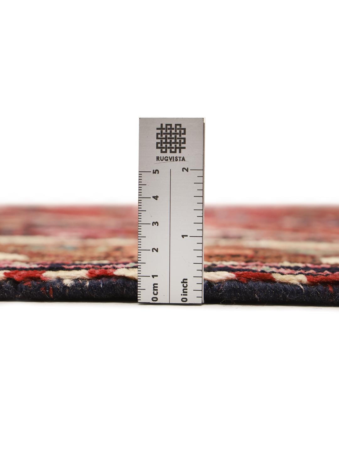 A hand-knotted Hamadan rug from the Middle East featuring a dark-red field with geometric motifs.