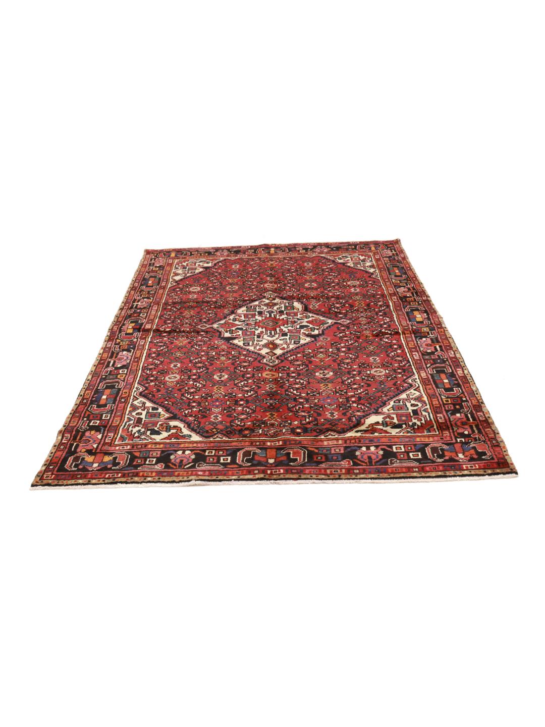 Hand-knotted Hosseinabad rug with geometric patterns in red and dark blue.