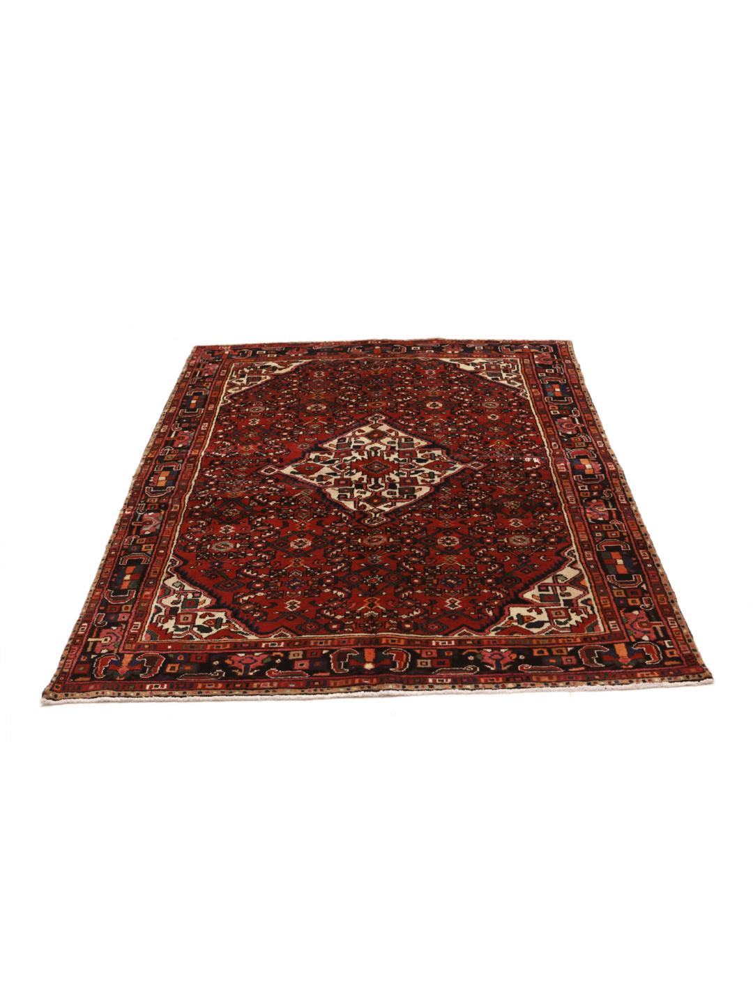 Hand-knotted Hosseinabad rug with geometric patterns in red and dark blue.