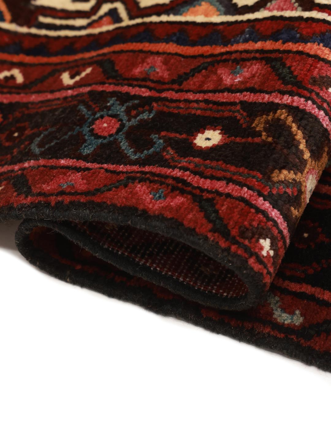 Hand-knotted Hosseinabad rug from the Middle East in dark-red with geometric motifs
