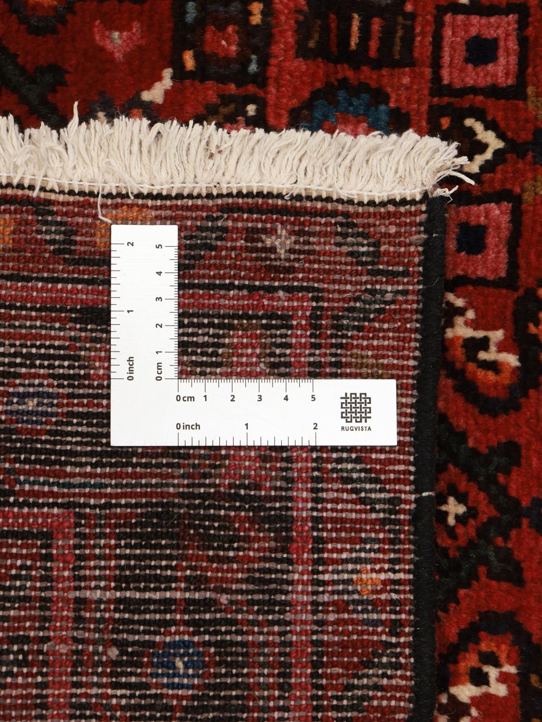 Hand-knotted Hosseinabad rug from the Middle East in dark-red with geometric motifs
