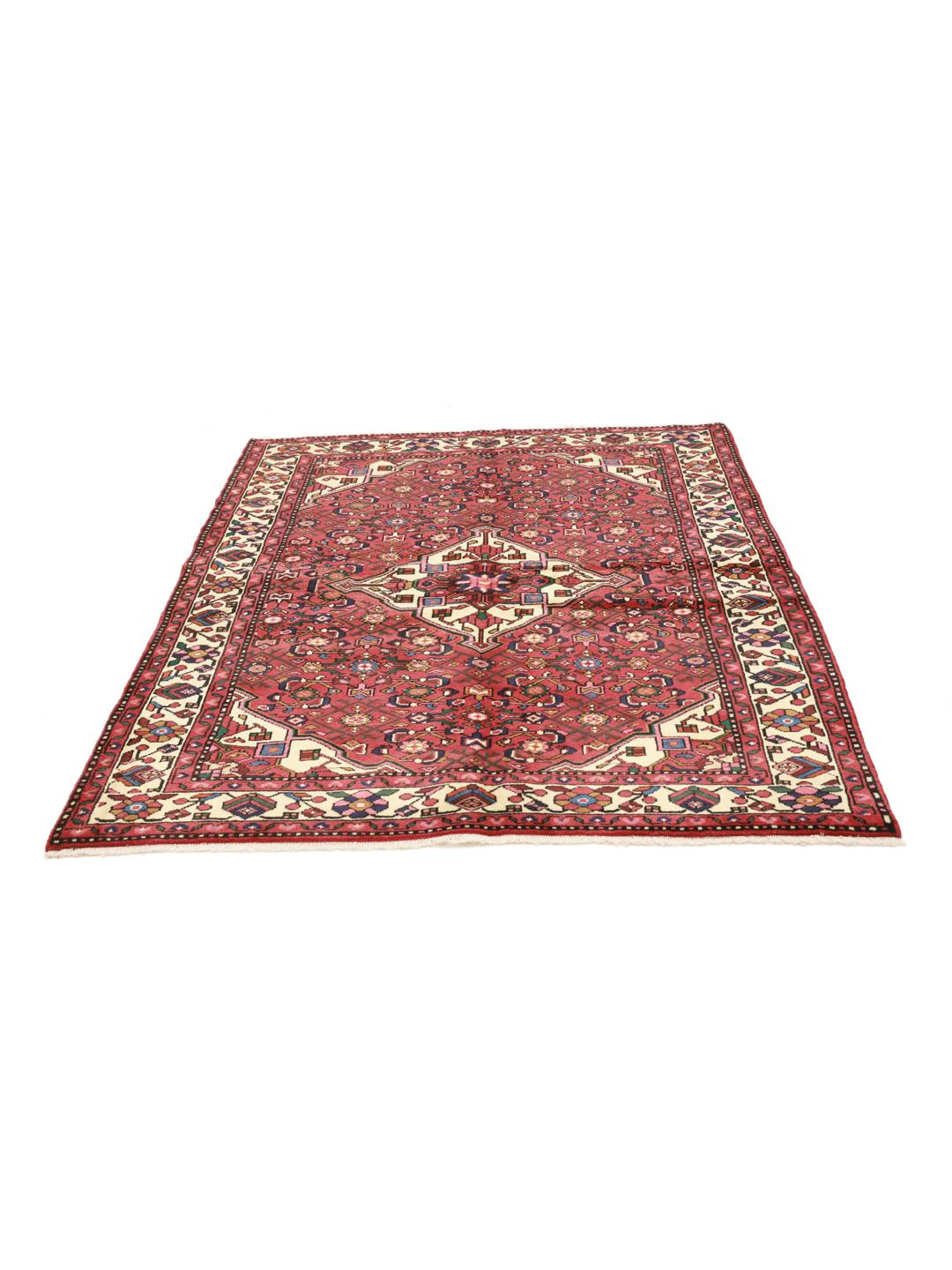 Hand-knotted Hosseinabad rug from the Middle East featuring a red field and a classic medallion pattern.