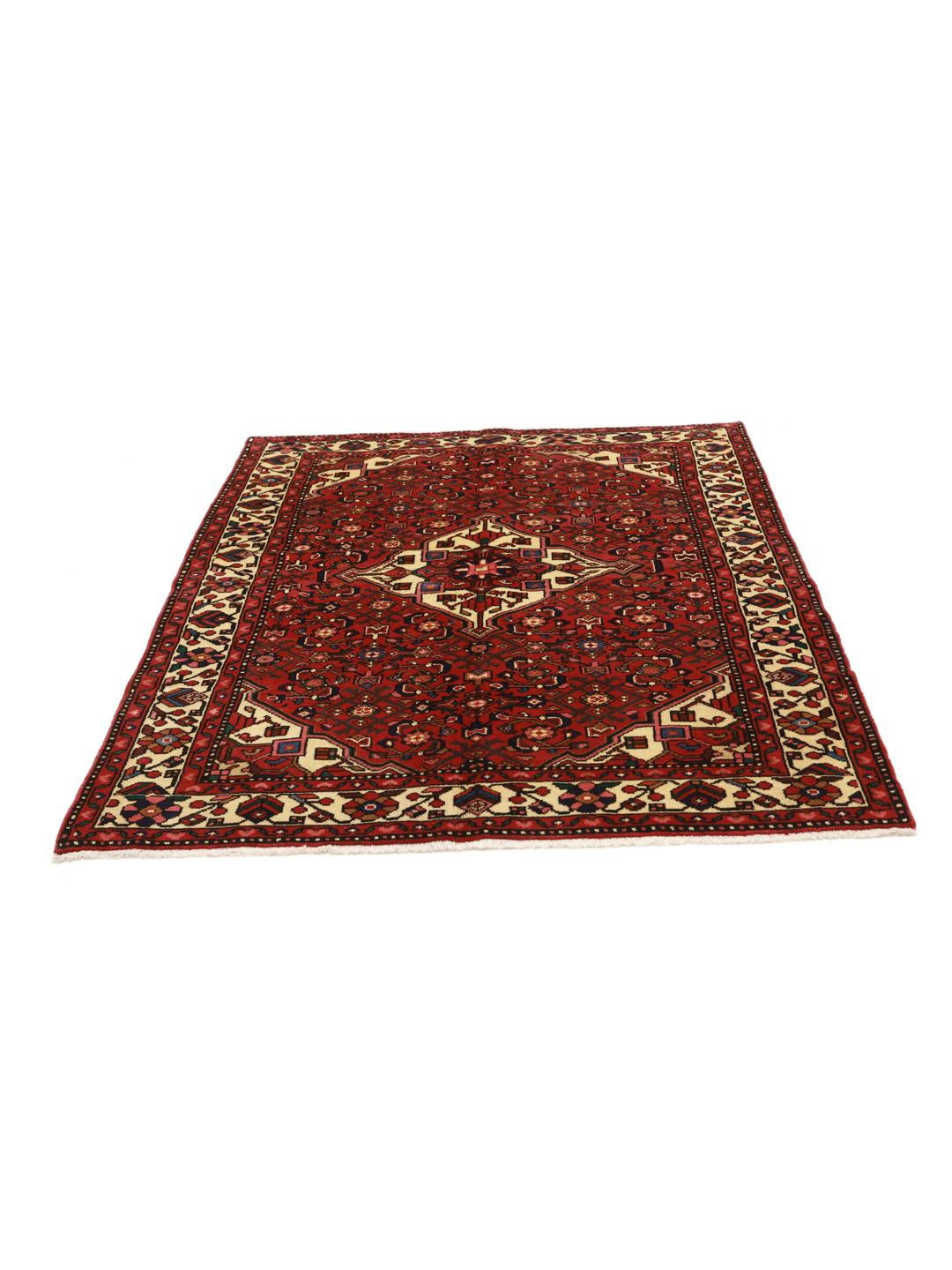 Hand-knotted Hosseinabad rug from the Middle East featuring a red field and a classic medallion pattern.